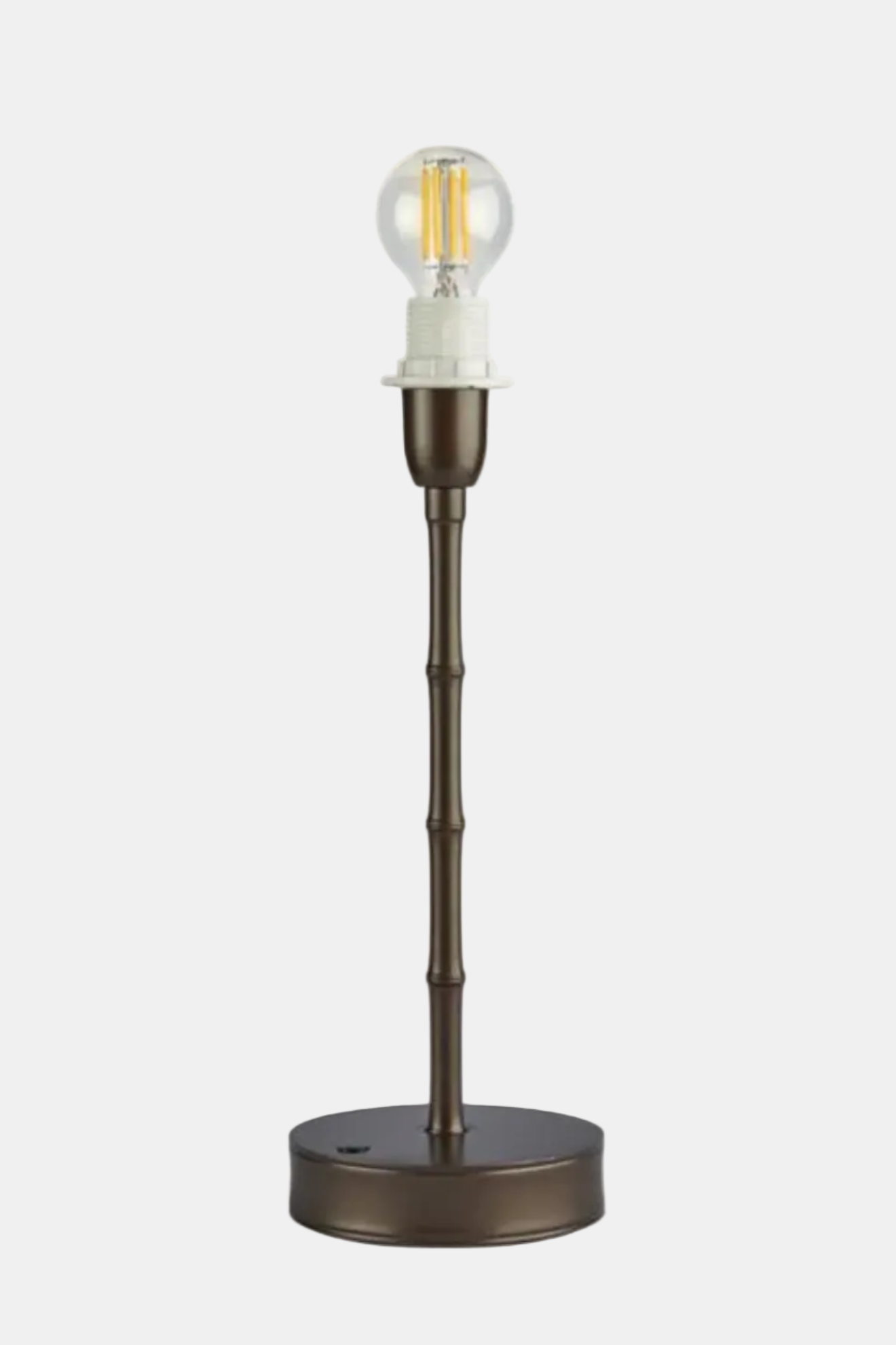 Bronze table lamp with a clear light bulb on a white background