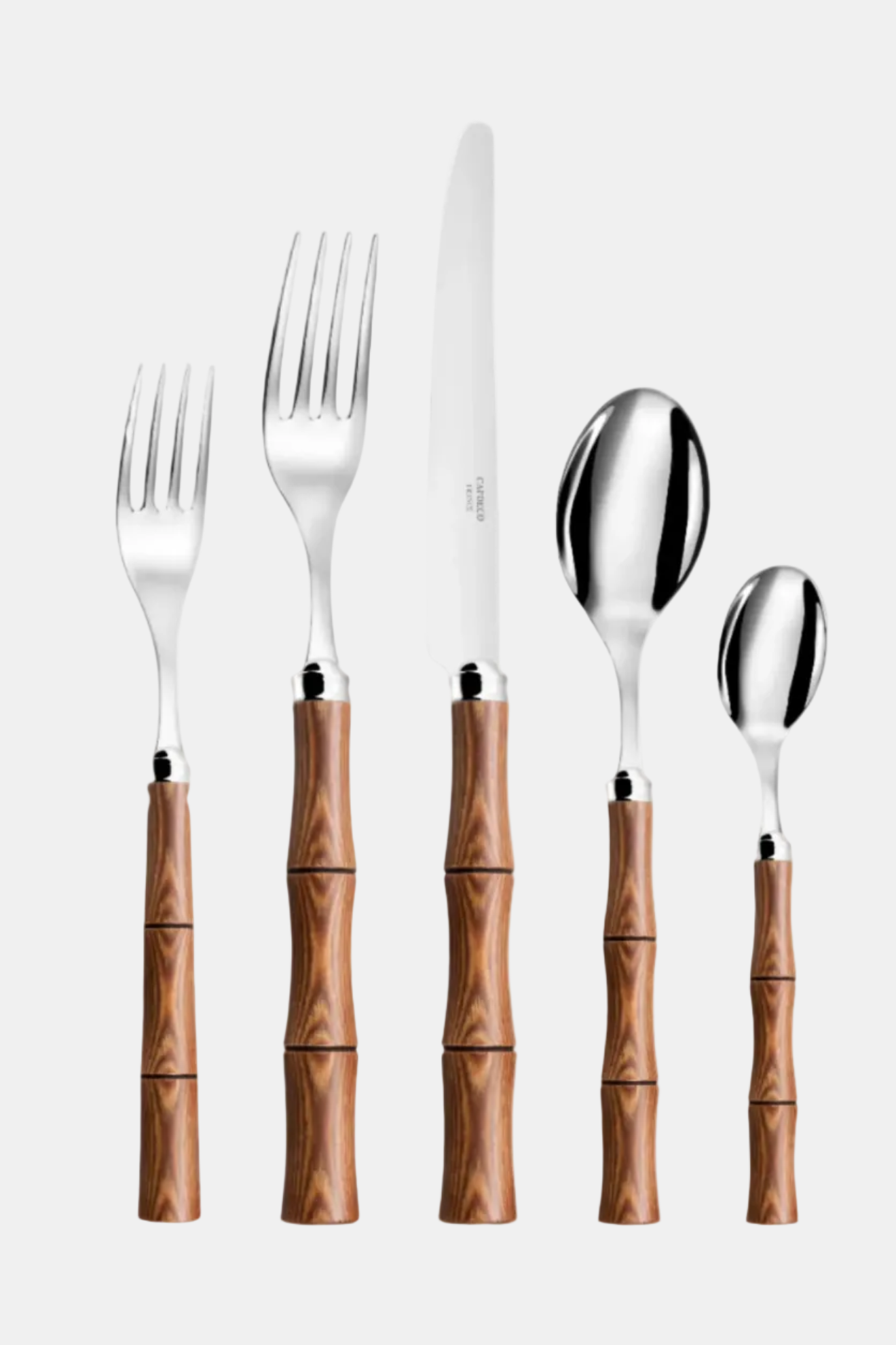 Set of silver cutlery with wooden handles on a white background