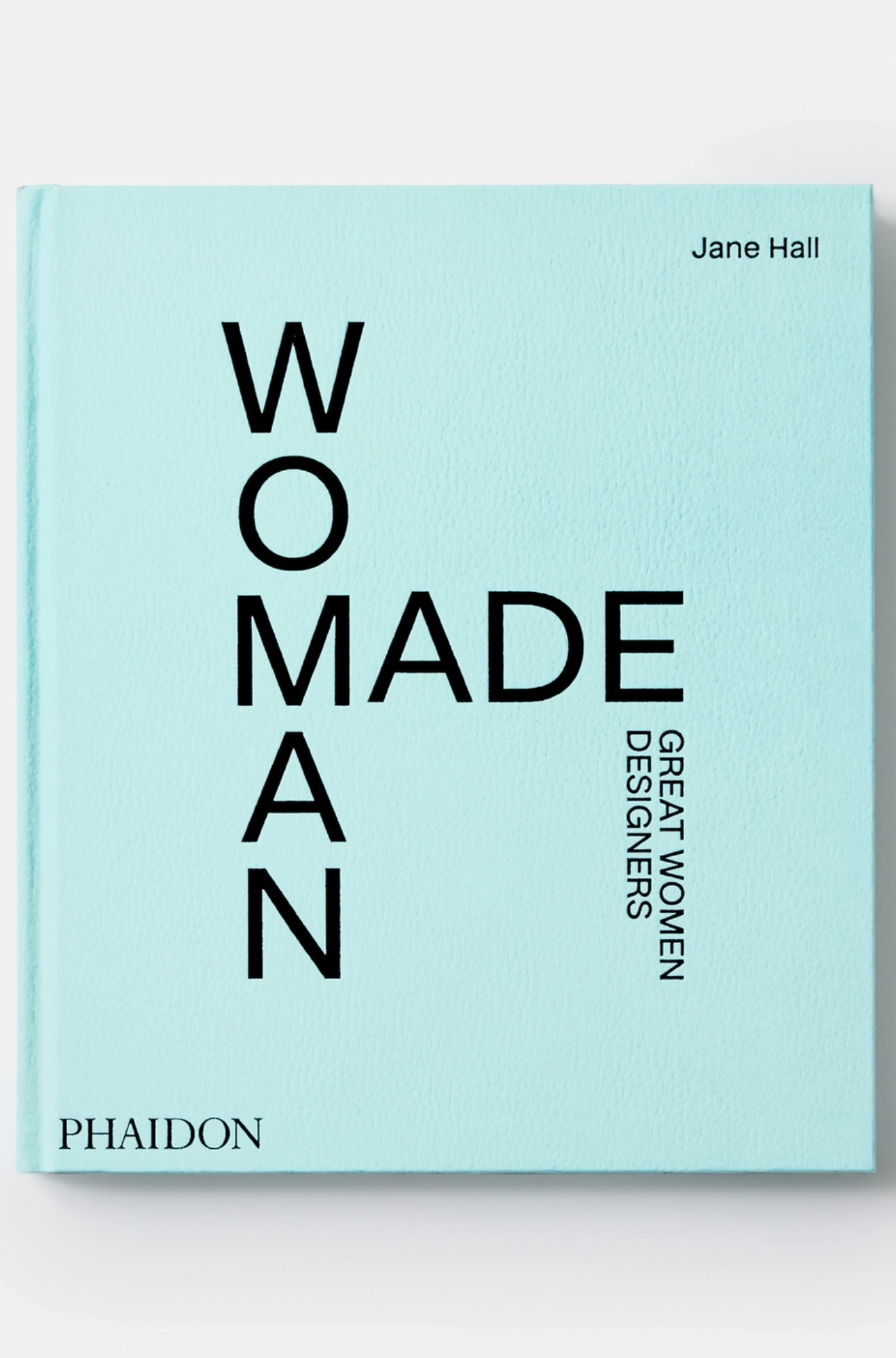 Book titled 'WOMADE: Great Women Designers' by Jane Hall on a light blue background