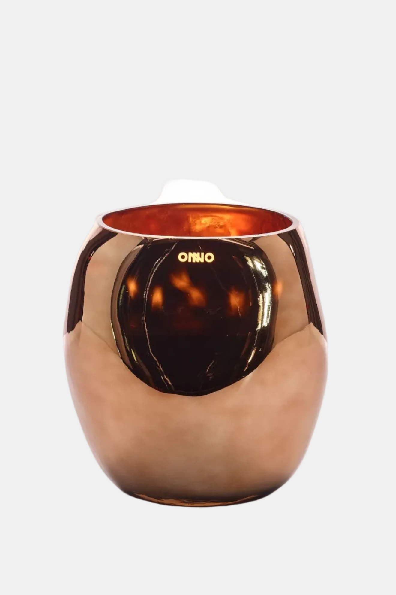 Bronze-colored candle holder with 'OMIO' branding on a white background