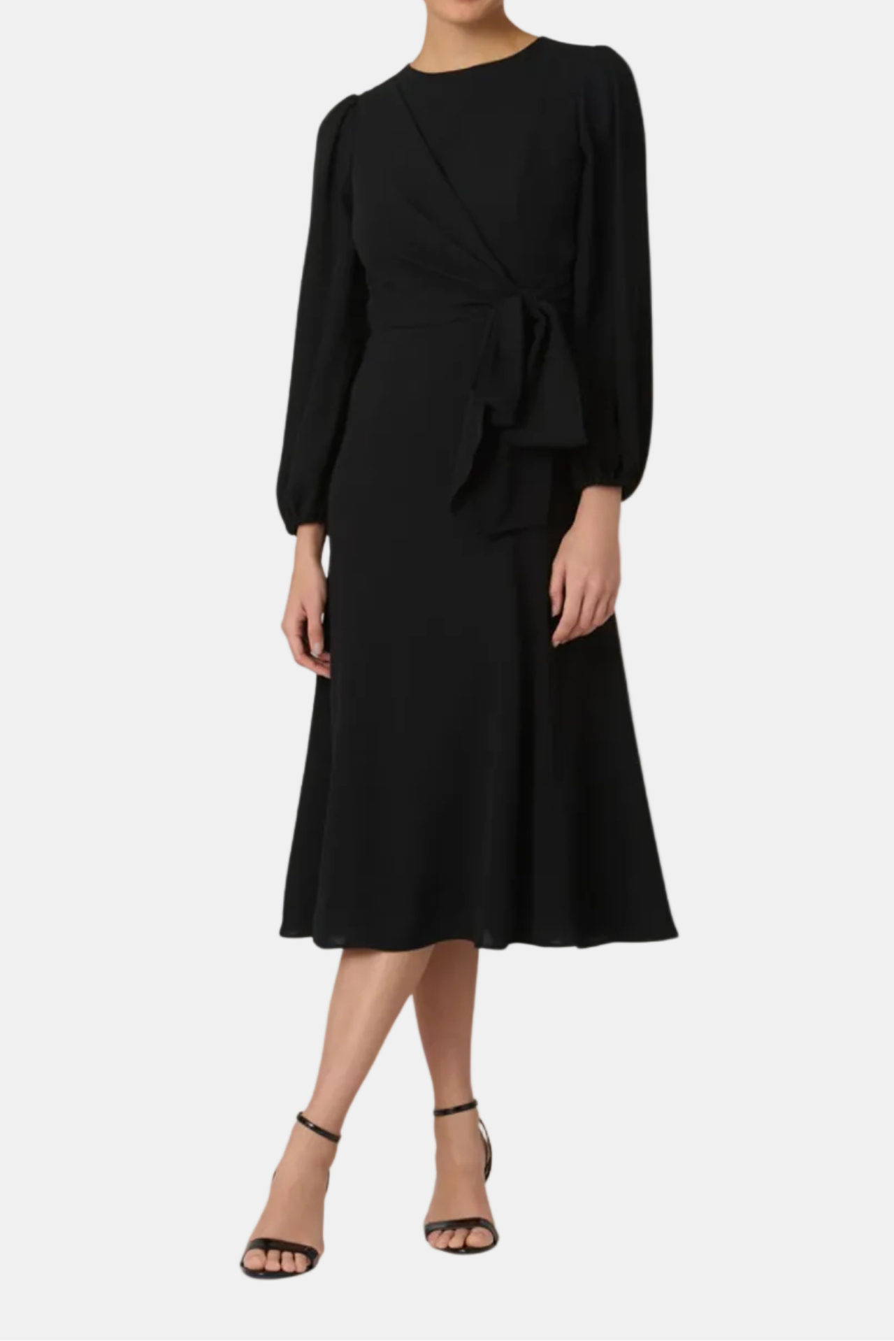 Black dress worn by a model on a white background