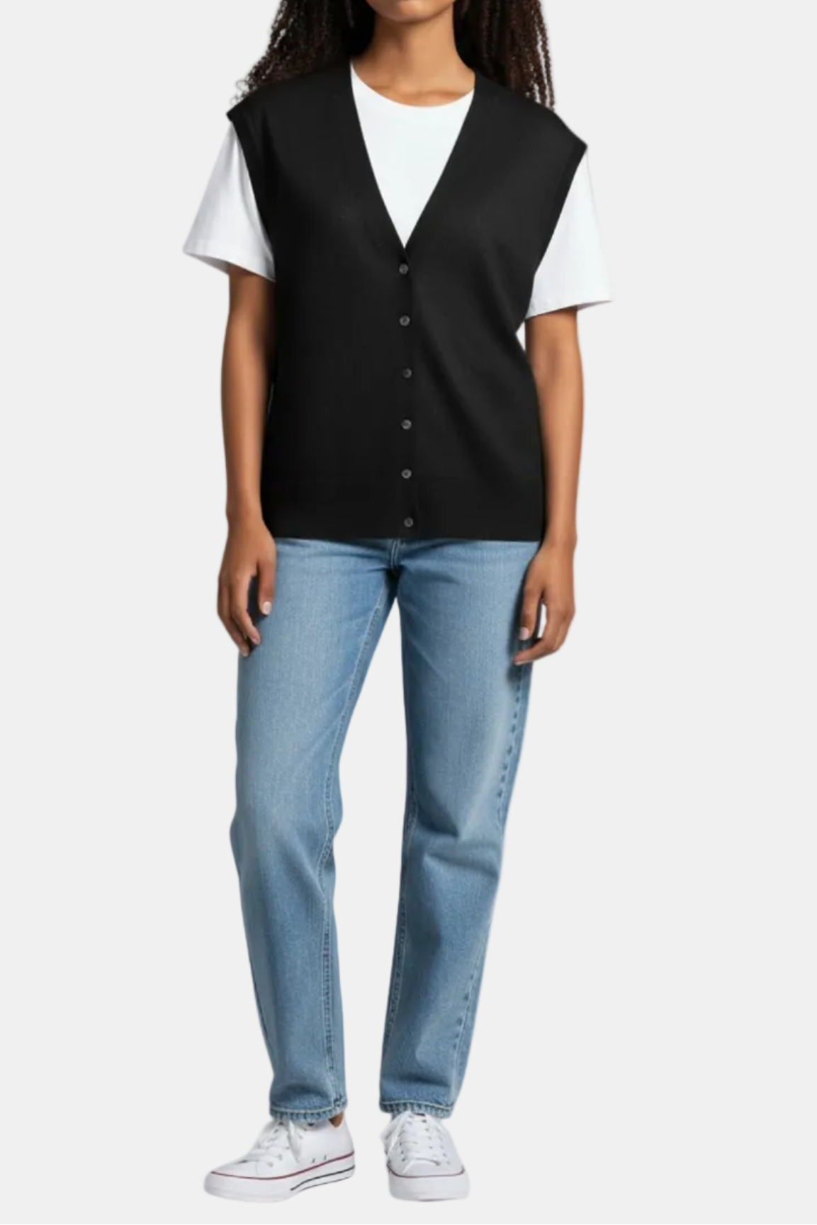 Person wearing a black vest over a white shirt with blue jeans on a white background