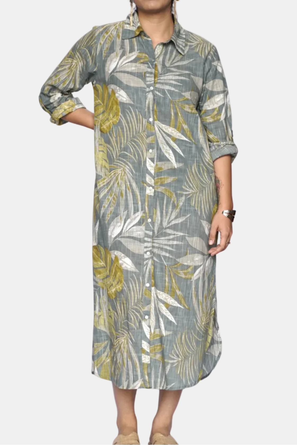 Woman wearing a long, patterned dress on a white background