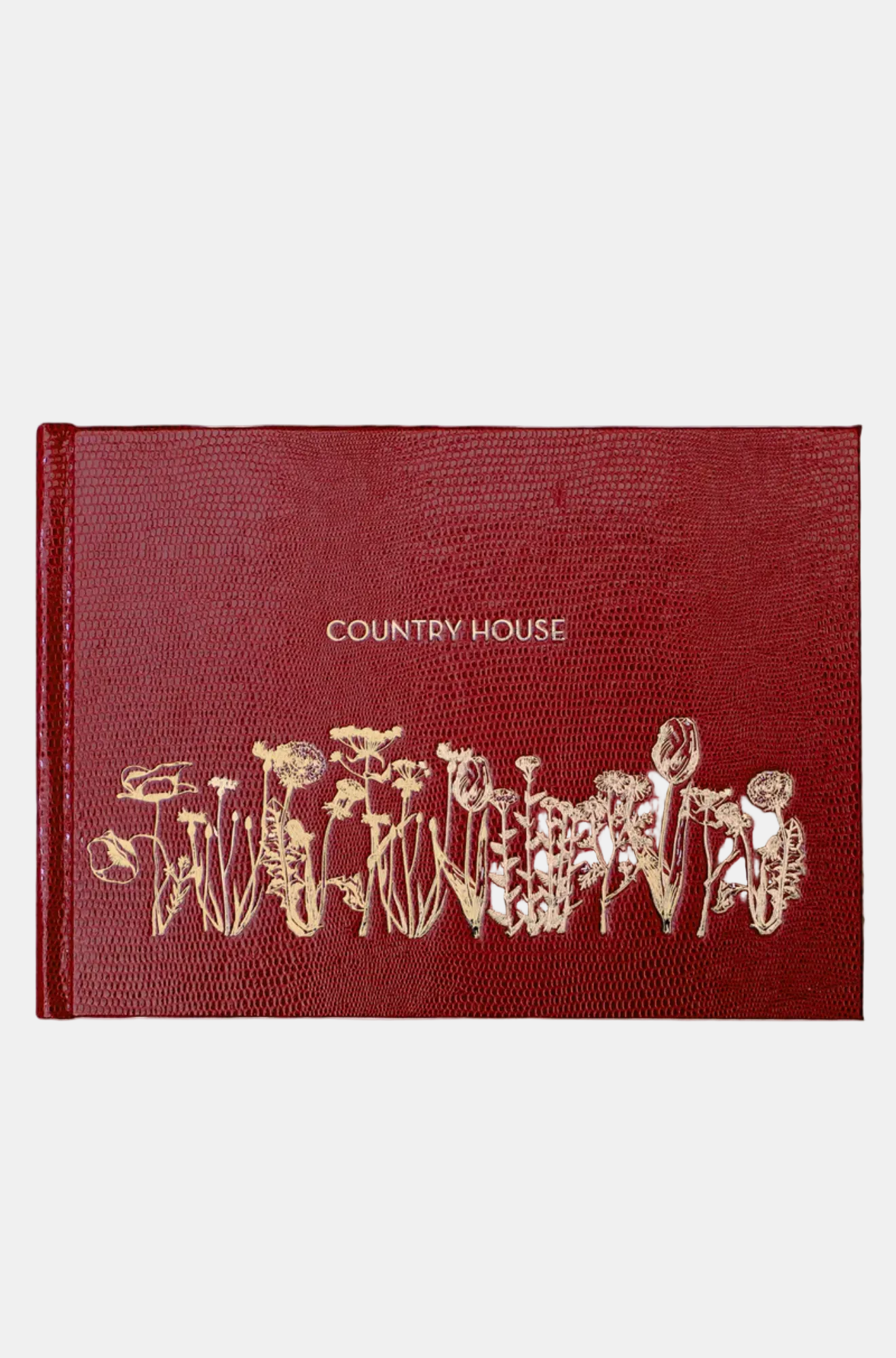 Red book with gold embossed design and 'Country House' text on a white background