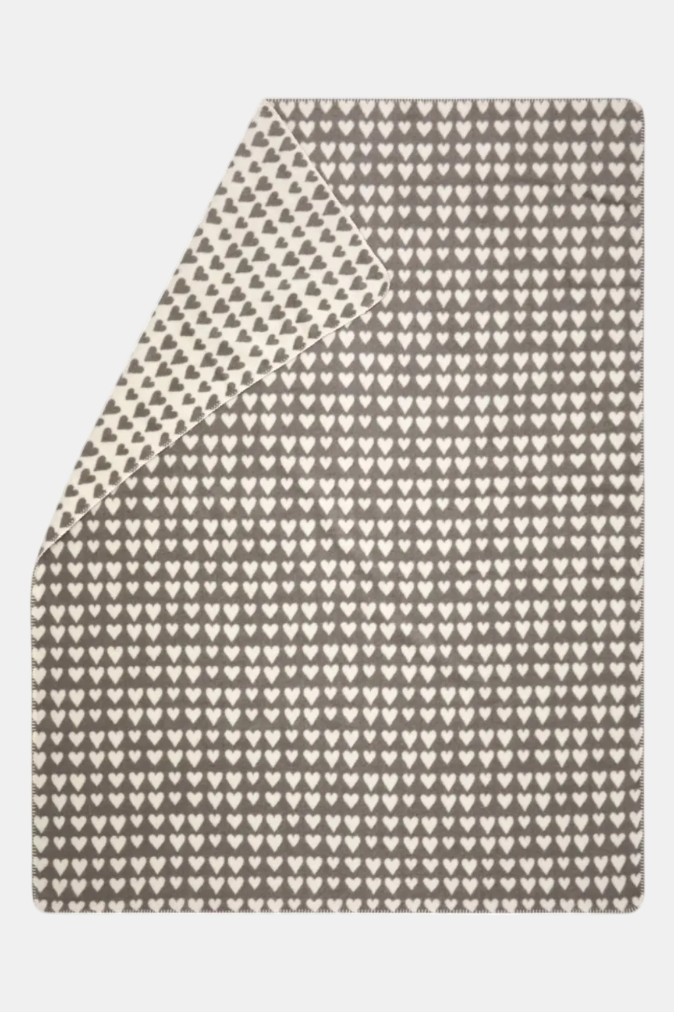 Textile with a pattern of small white hearts on a beige background