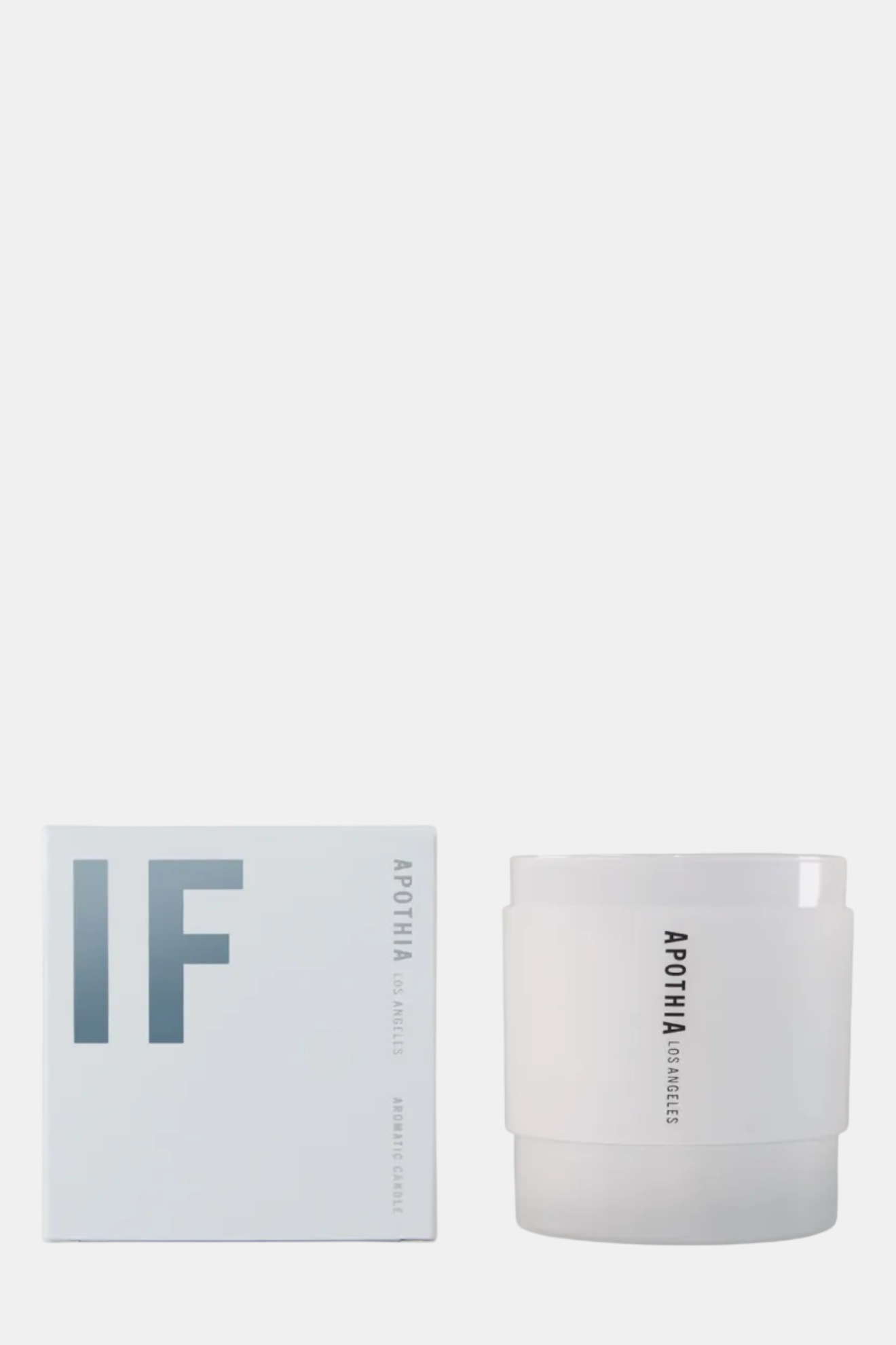 White candle with 'APOTHE' branding next to its packaging on a white background