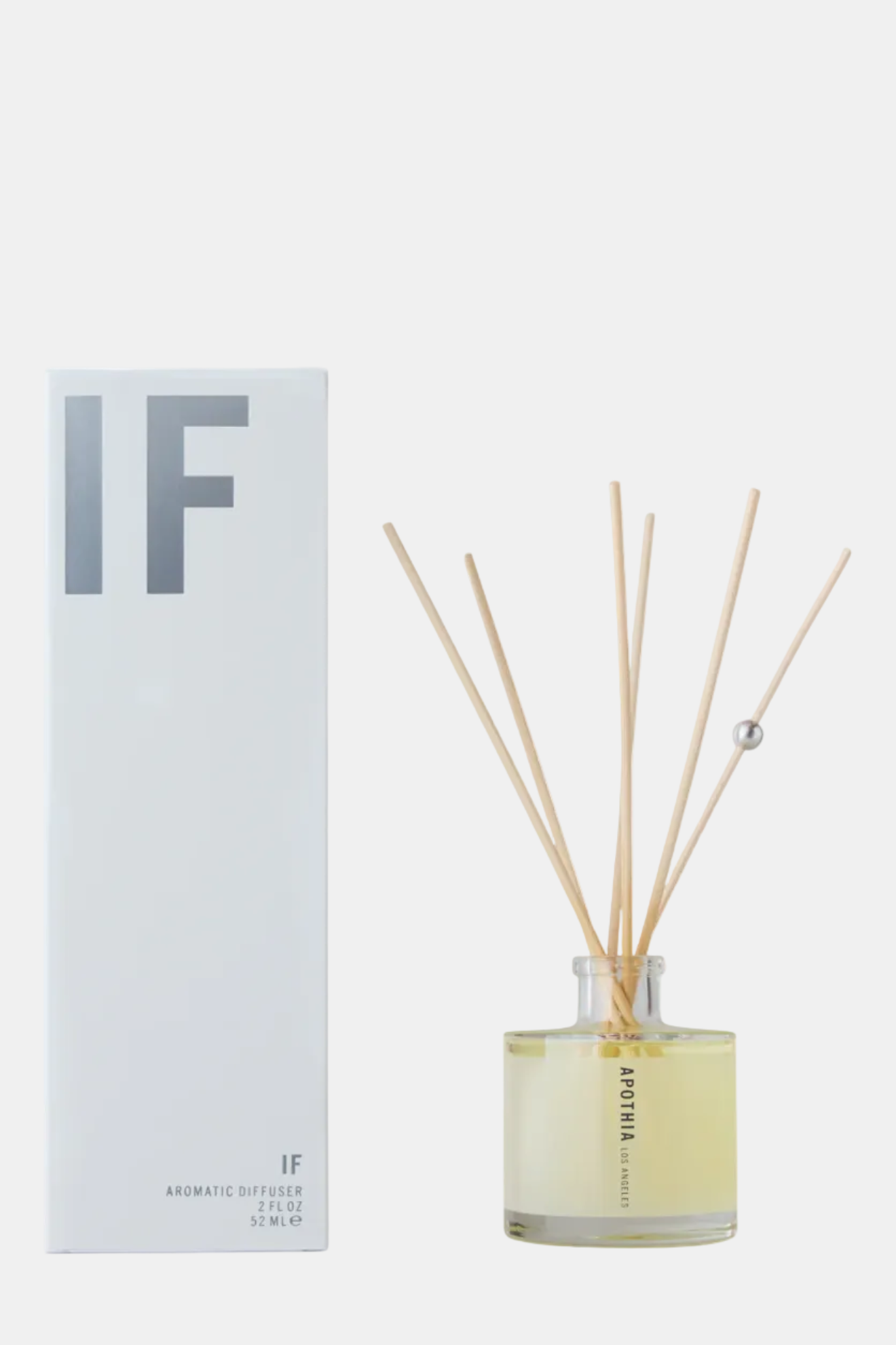 Reed diffuser with 'IF' branding next to its packaging on a white background