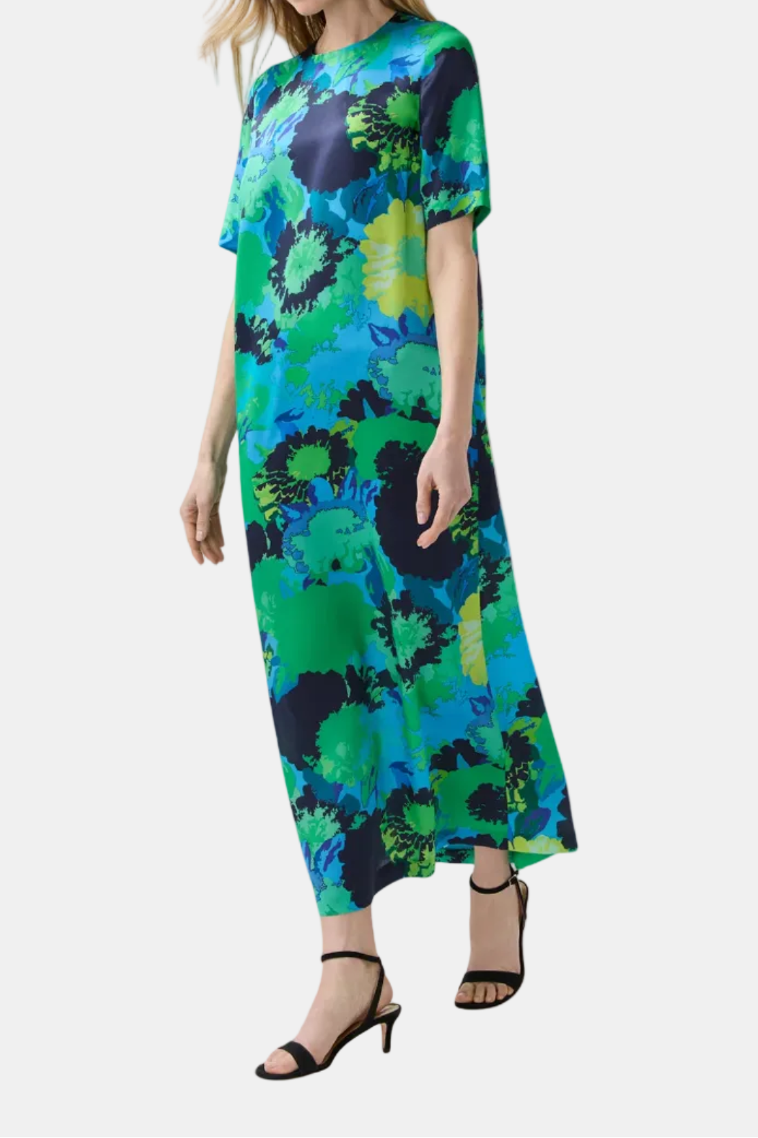 Woman wearing a colorful floral dress on a white background