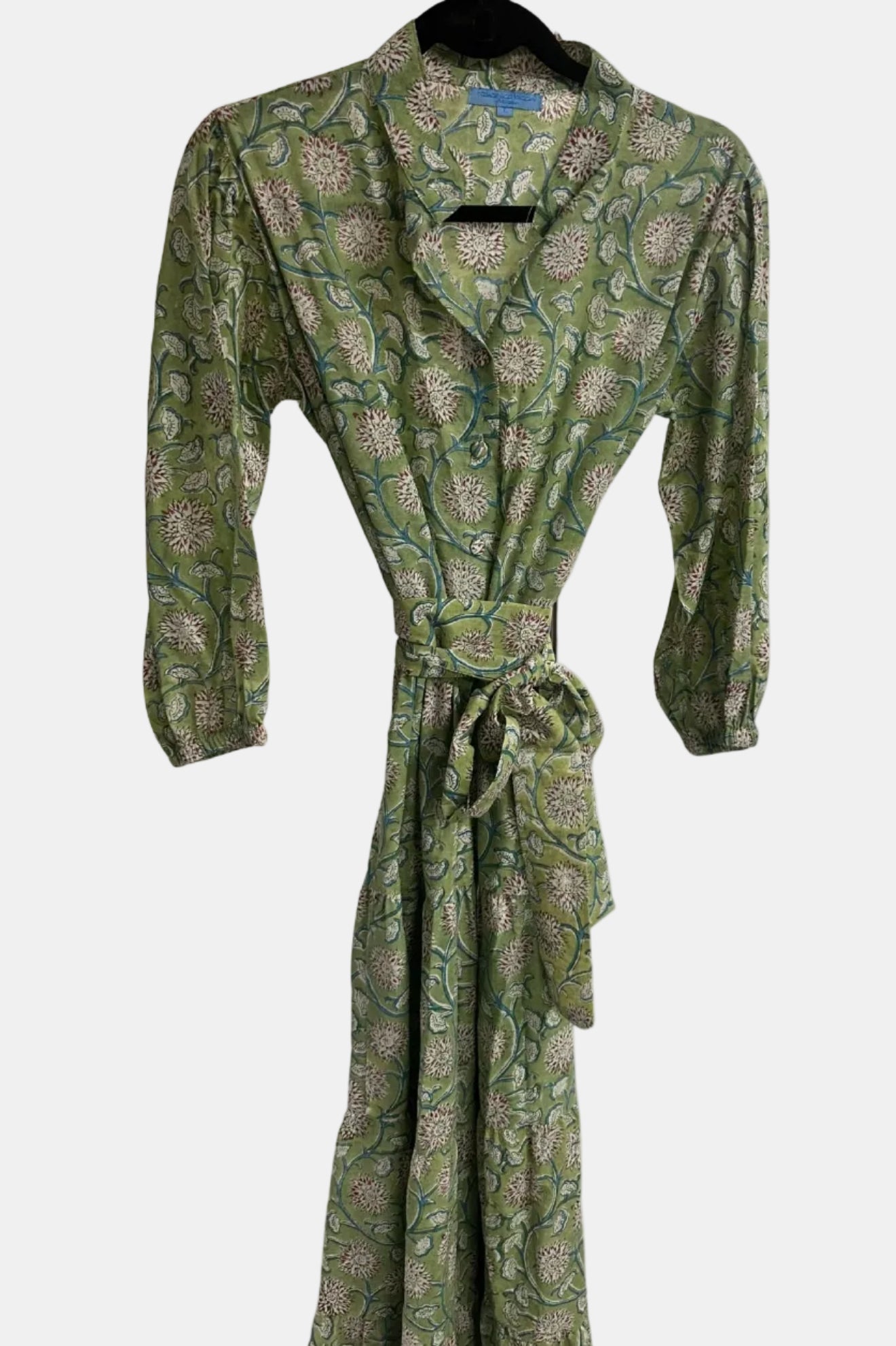 Green patterned robe on a hanger against a white background