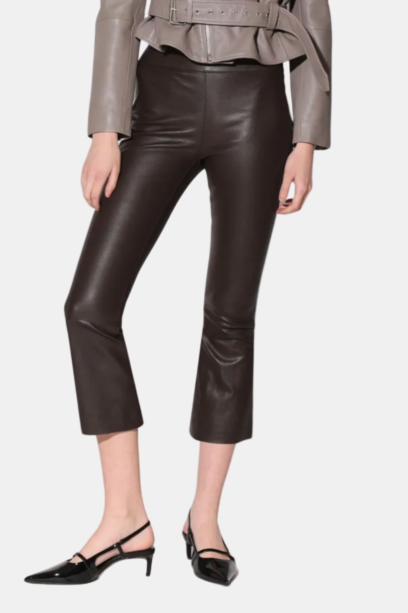 A pair of black Luisa Pant crop flare silhouette leather pants with a model standing against a white background.