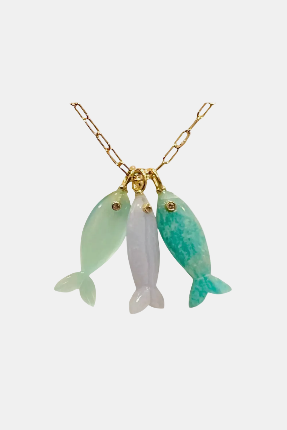 A gold chain necklace featuring three dangling fish-shaped charms made of polished stone. The left fish is light mint green, the center fish is pale lavender-white, and the right fish is teal with darker marbled green patterns.