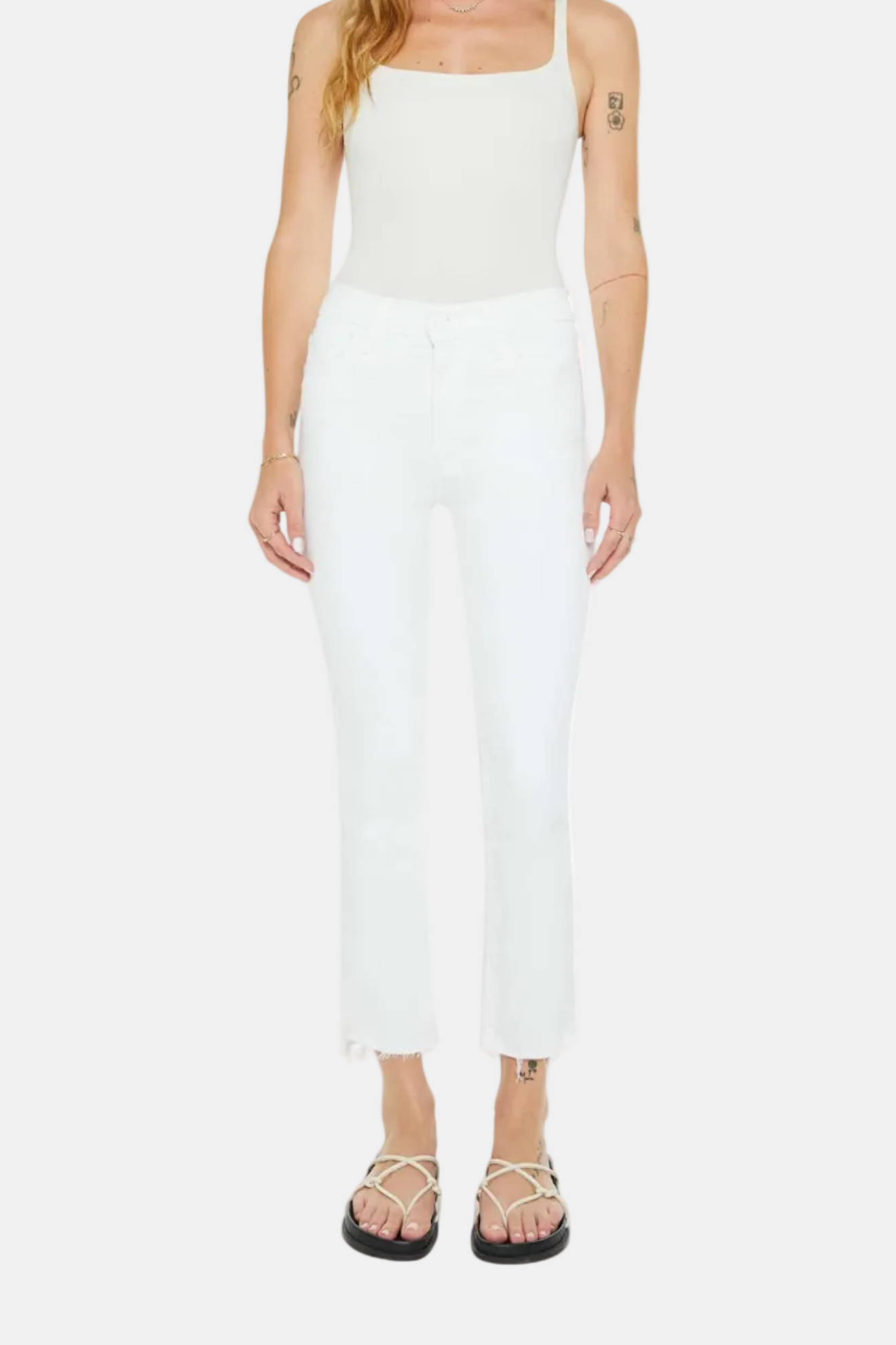 Person wearing a white sleeveless top and pants on a white background