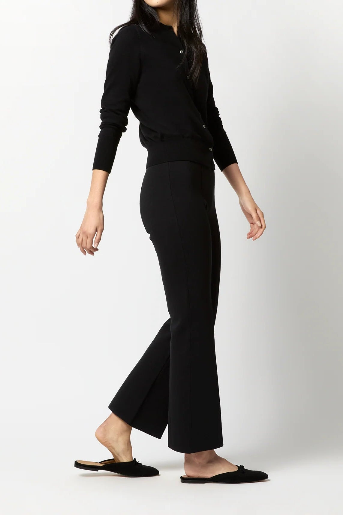 Woman wearing a black outfit on a white background