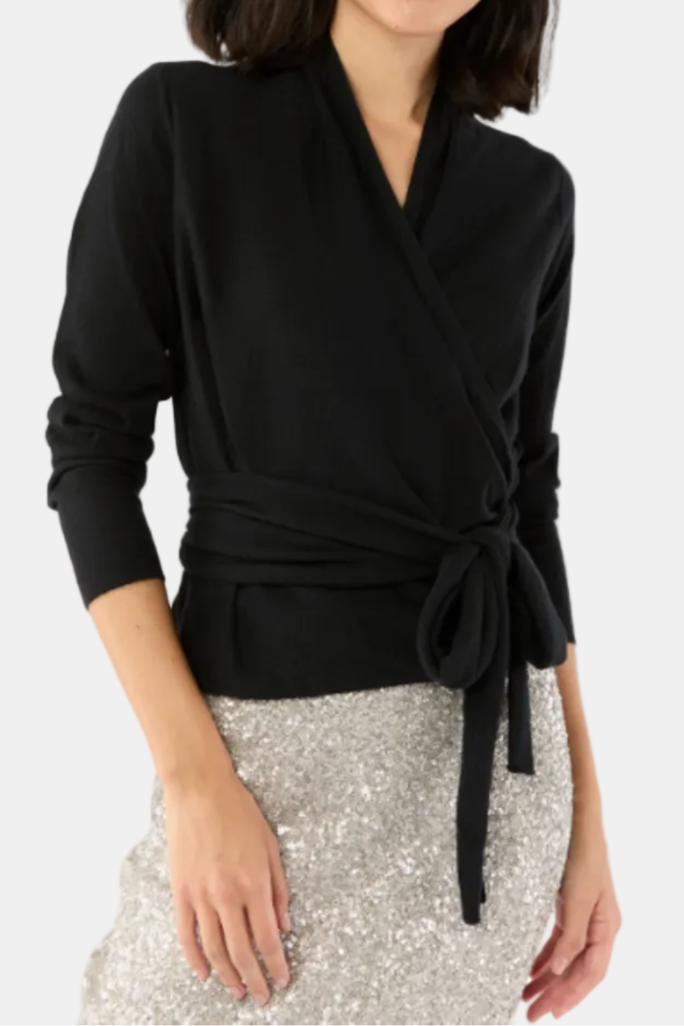 Woman wearing a black wrap top with a white background