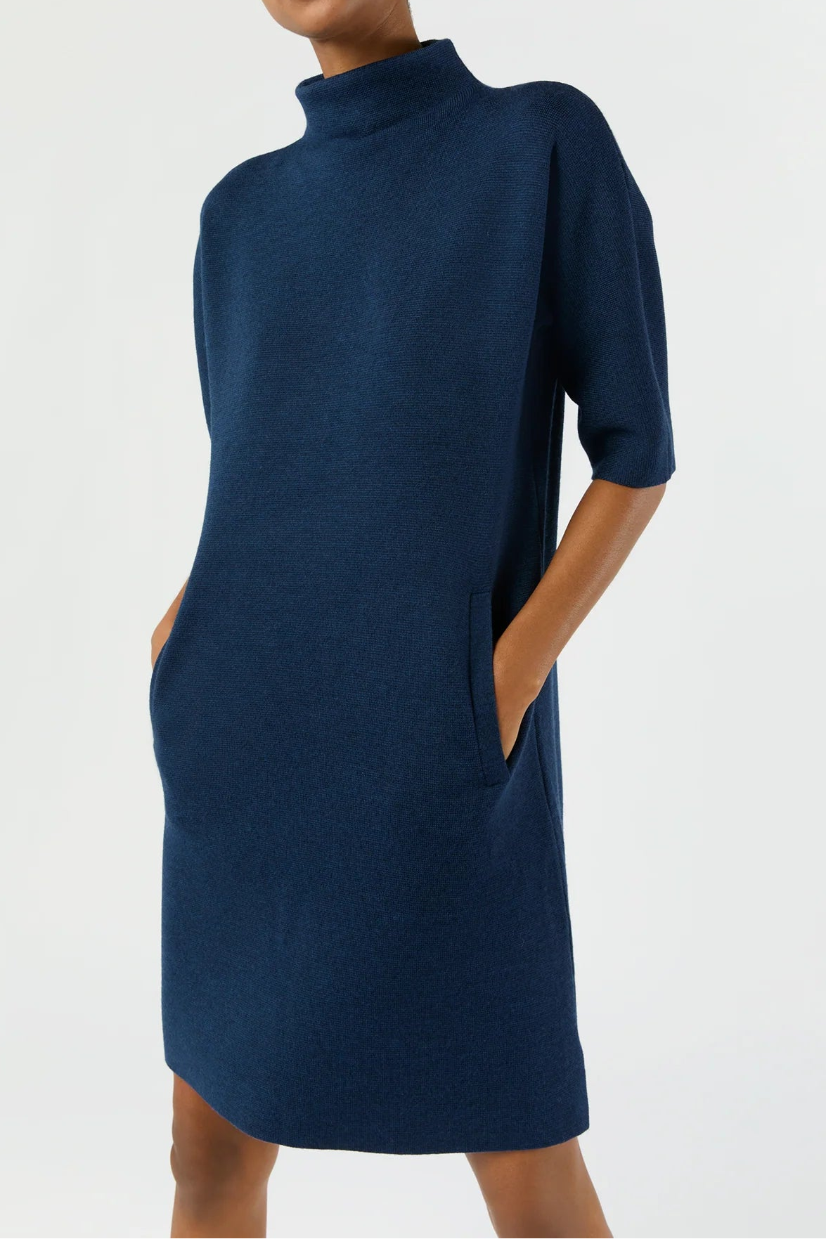 Woman wearing a navy blue dress against a white background