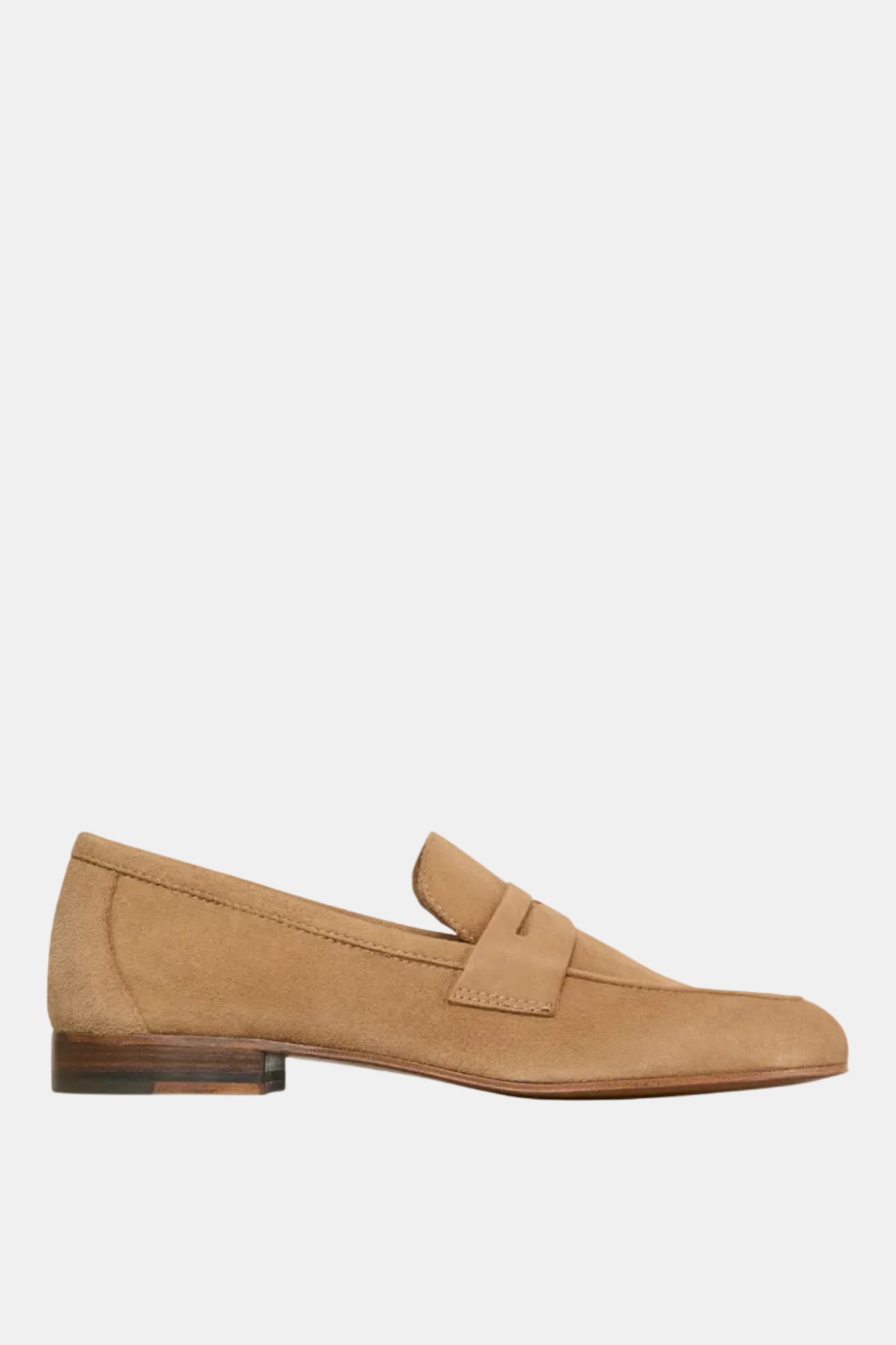 A single camel-colored unlined suede penny loafer shoe.