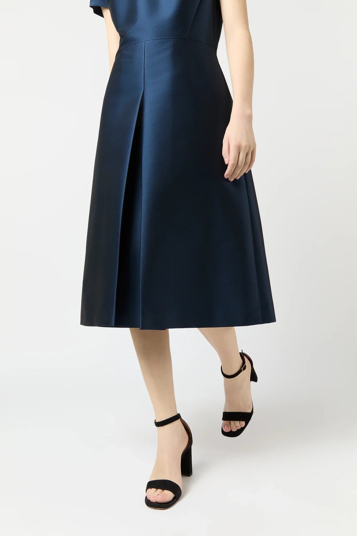 Navy blue dress worn by a person on a white background