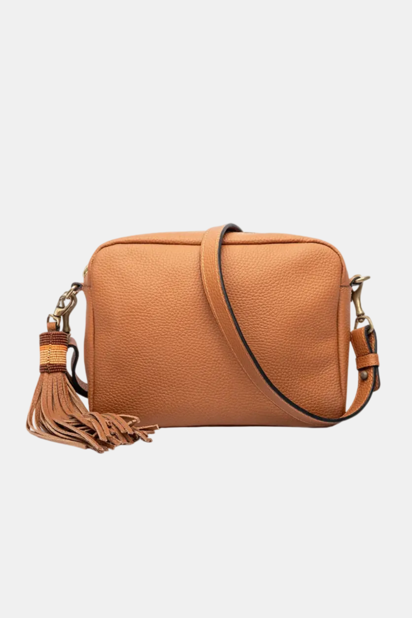 A brown leather handbag with a long shoulder strap, a tassel on the zipper, and a detachable shoulder strap.