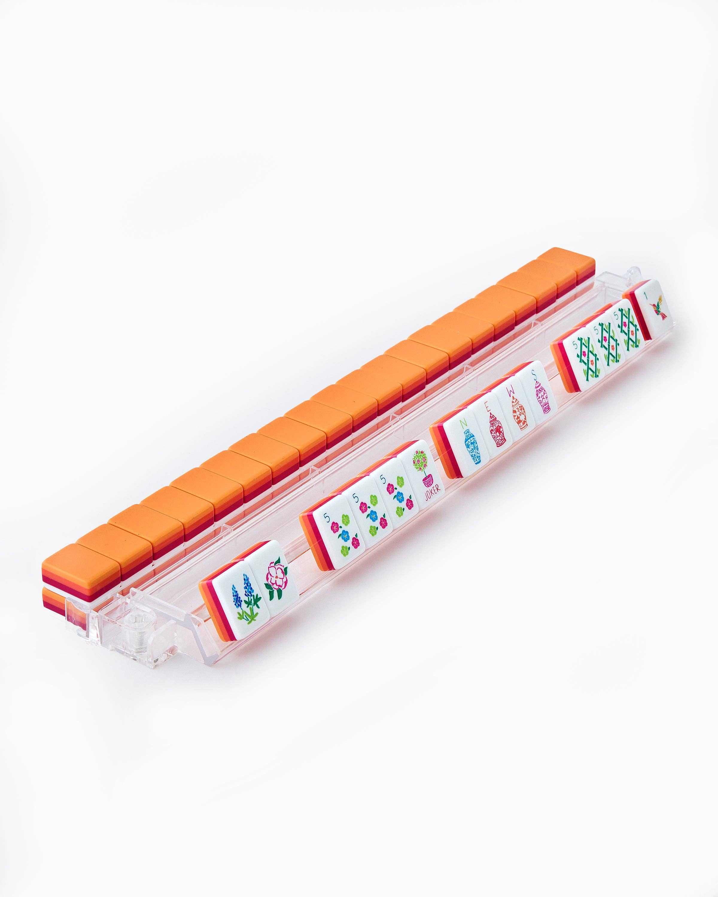 Small rectangular container with orange lid and colorful labels on a white background