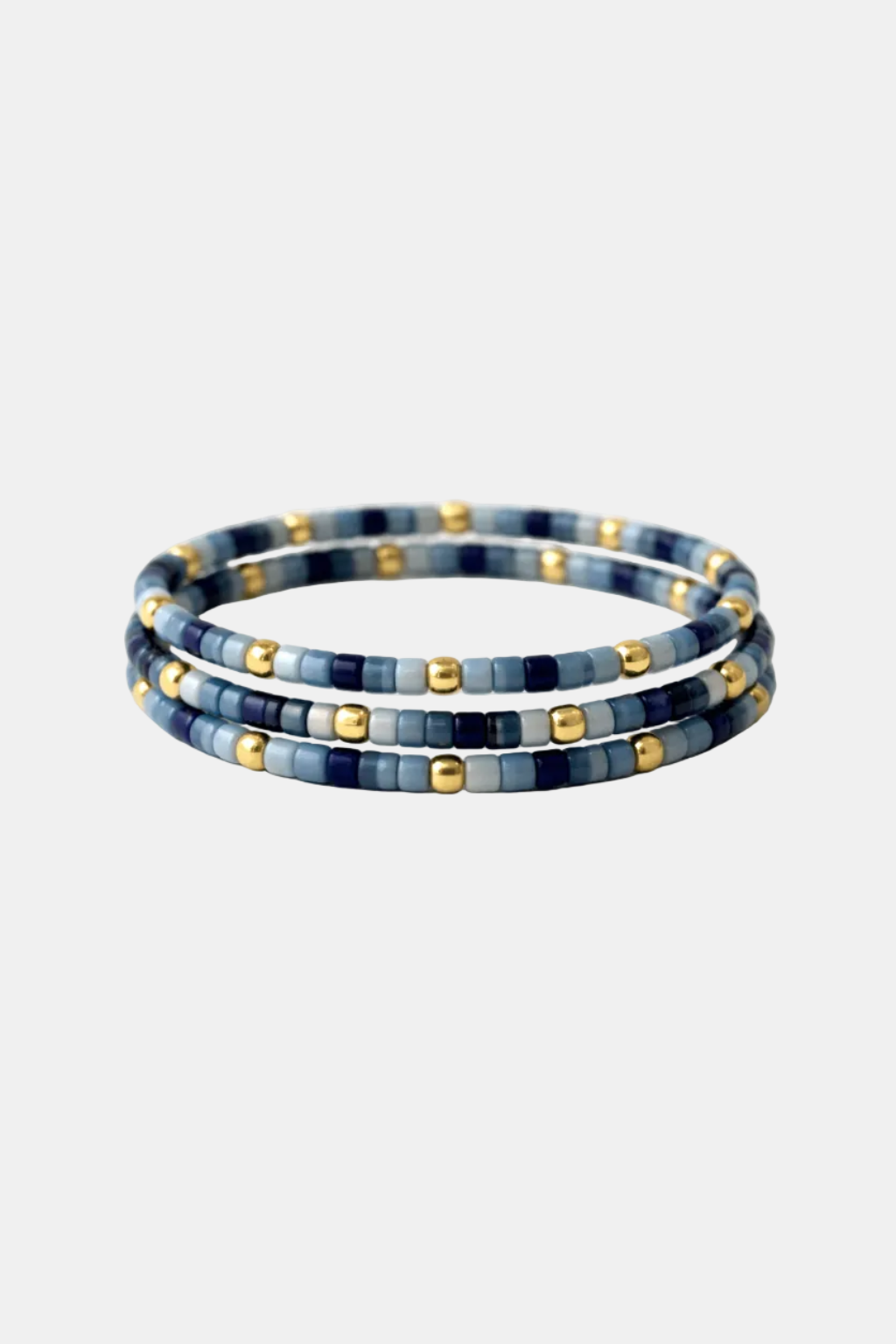 Set of three blue and gold beaded bracelets on a white background