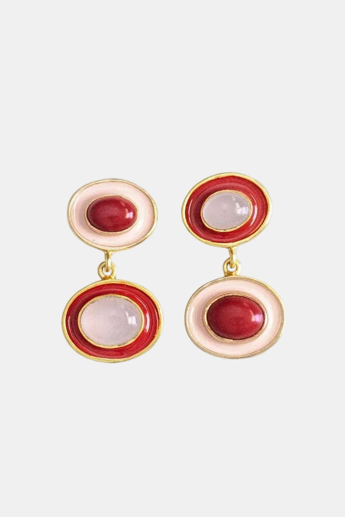Pair of earrings with red and pink stones on a white background