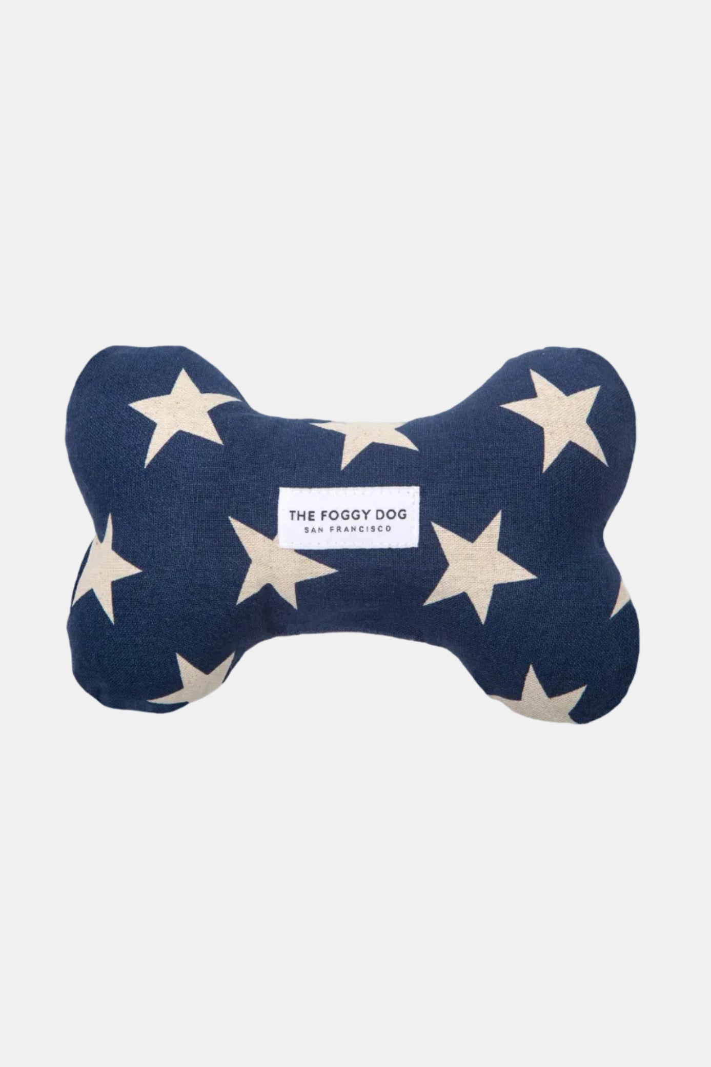 Navy blue bone-shaped pillow with beige stars and 'The Foggy Dog' label on a white background