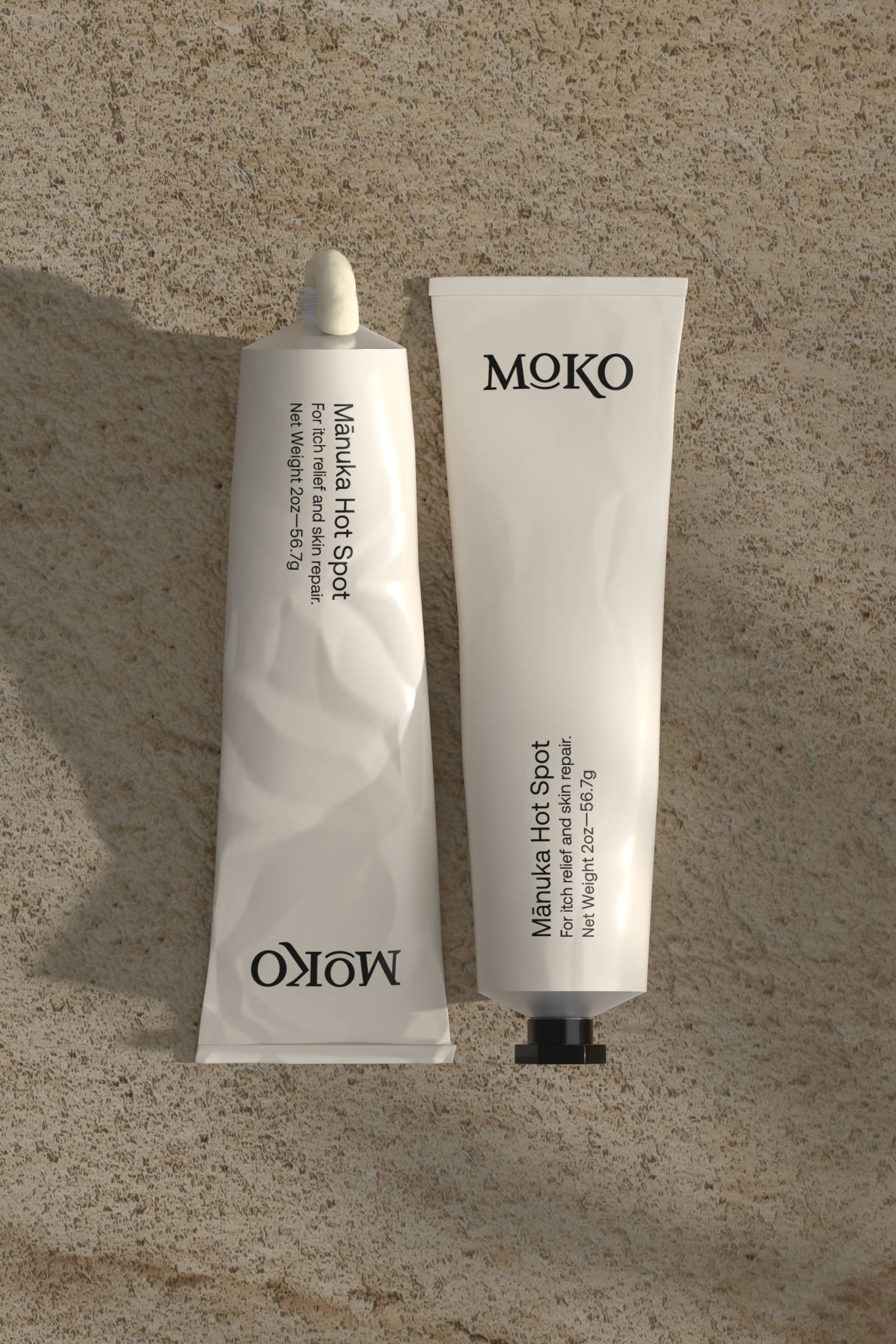 Two MOKO skincare products on a textured beige surface