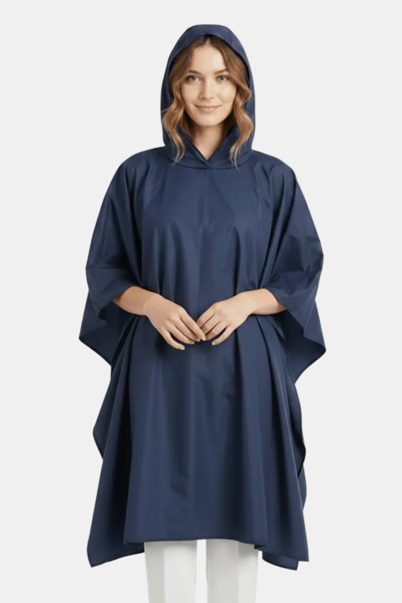 Woman wearing a navy blue rain poncho on a white background