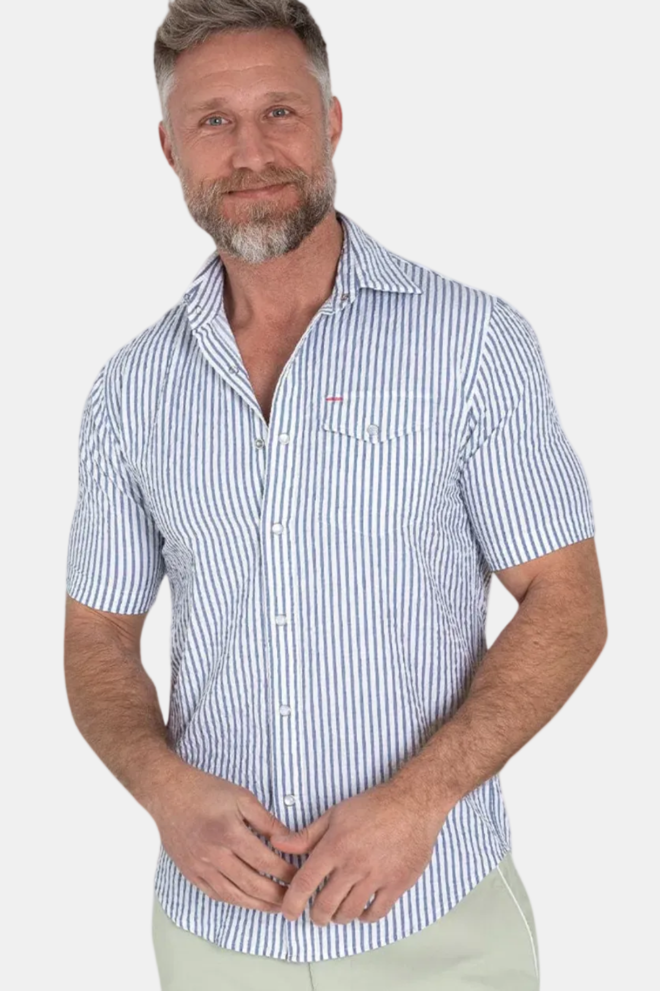 A man wearing a short sleeve striped performance pearl snap shirt in blue and white, with a collar and button-up neck.