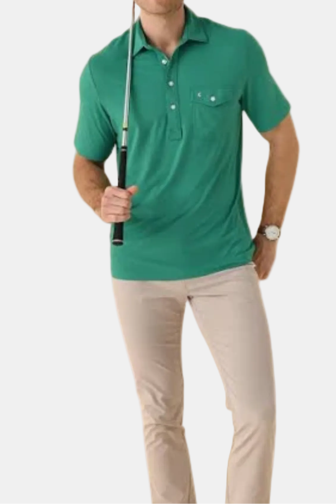 Man wearing a green polo shirt and beige pants holding a golf club on a white background