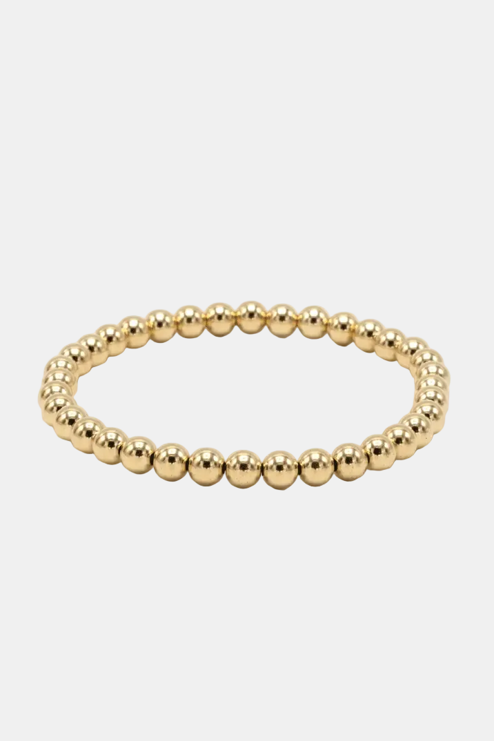 Gold beaded bracelet on a white background