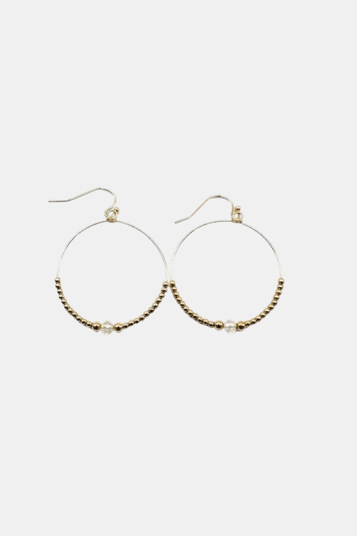 Gold hoop earrings with beaded accents on a white background
