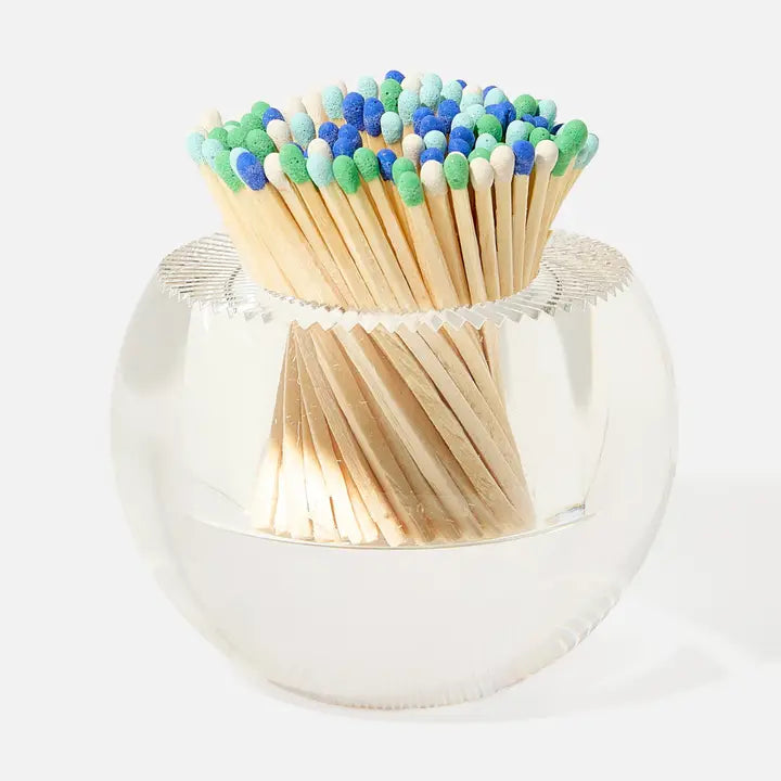 Matches with colorful heads in a metallic holder on a white background
