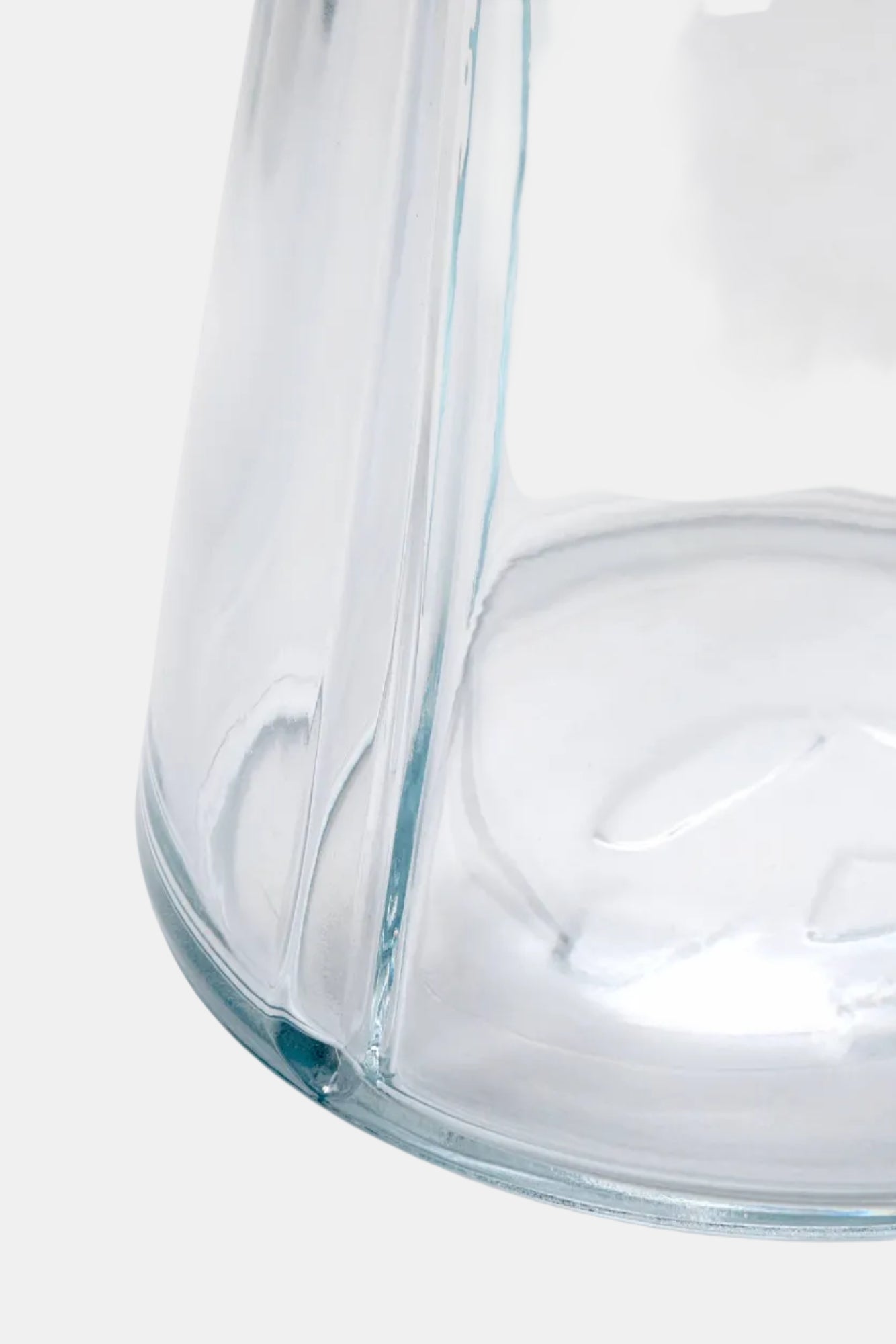 Clear glass carafe on a white background