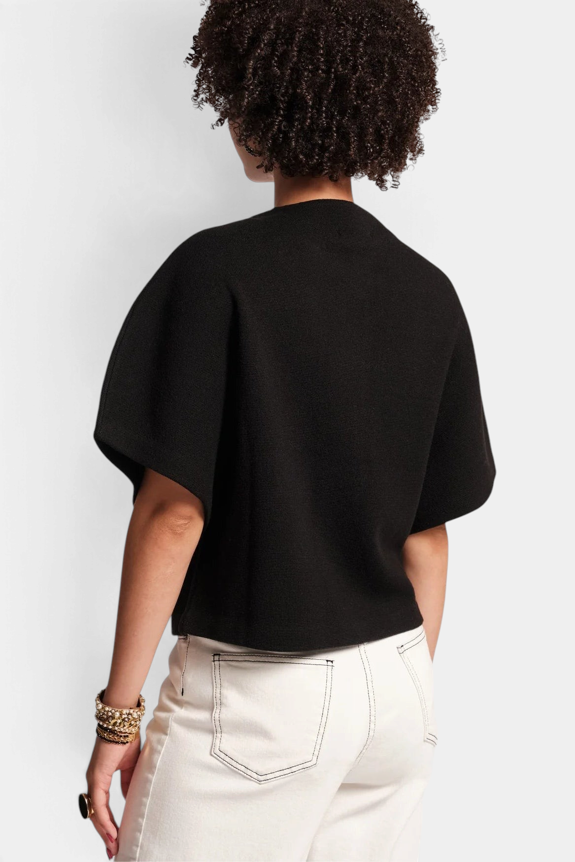 Frances Valentine Carnegie black merino wool shrug with half-length batwing sleeves worn from the back view