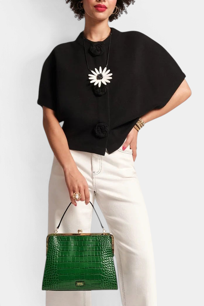 Frances Valentine Carnegie black merino wool shrug with half sleeves and floral button details worn by a model