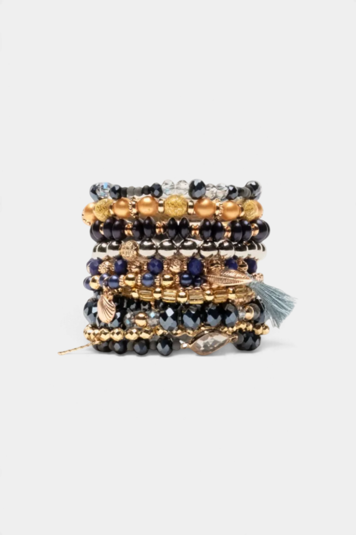 Frances Valentine handmade stacked bracelet set featuring multi-textured gold, navy, and black beads with tassel charm.
