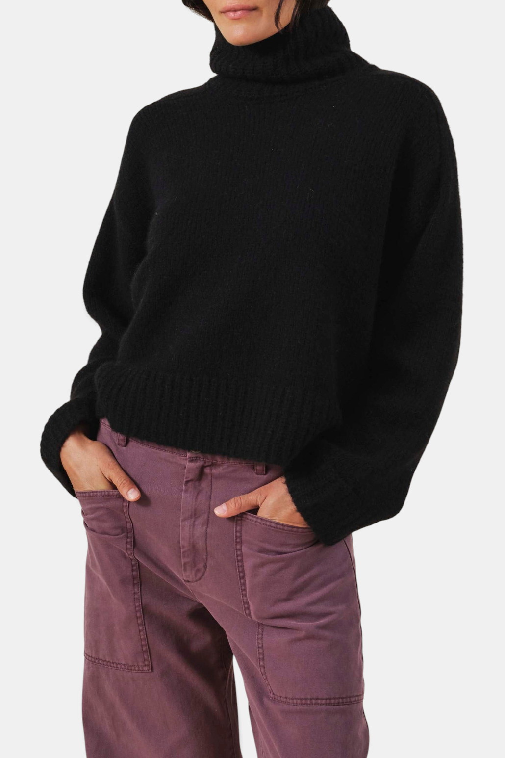 The Copper Shed black cashmere blend turtleneck sweater with a relaxed fit and ribbed trim.