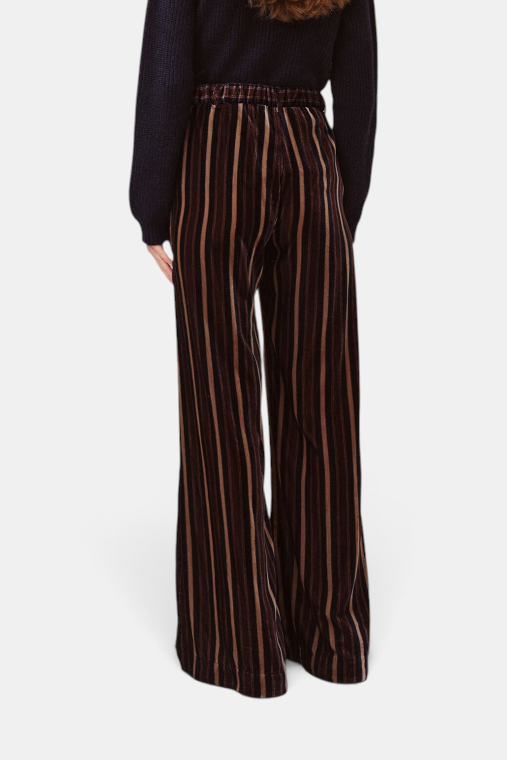 The Copper Shed Piedro trousers in brown striped velvet with a relaxed wide-leg fit, viewed from the back.
