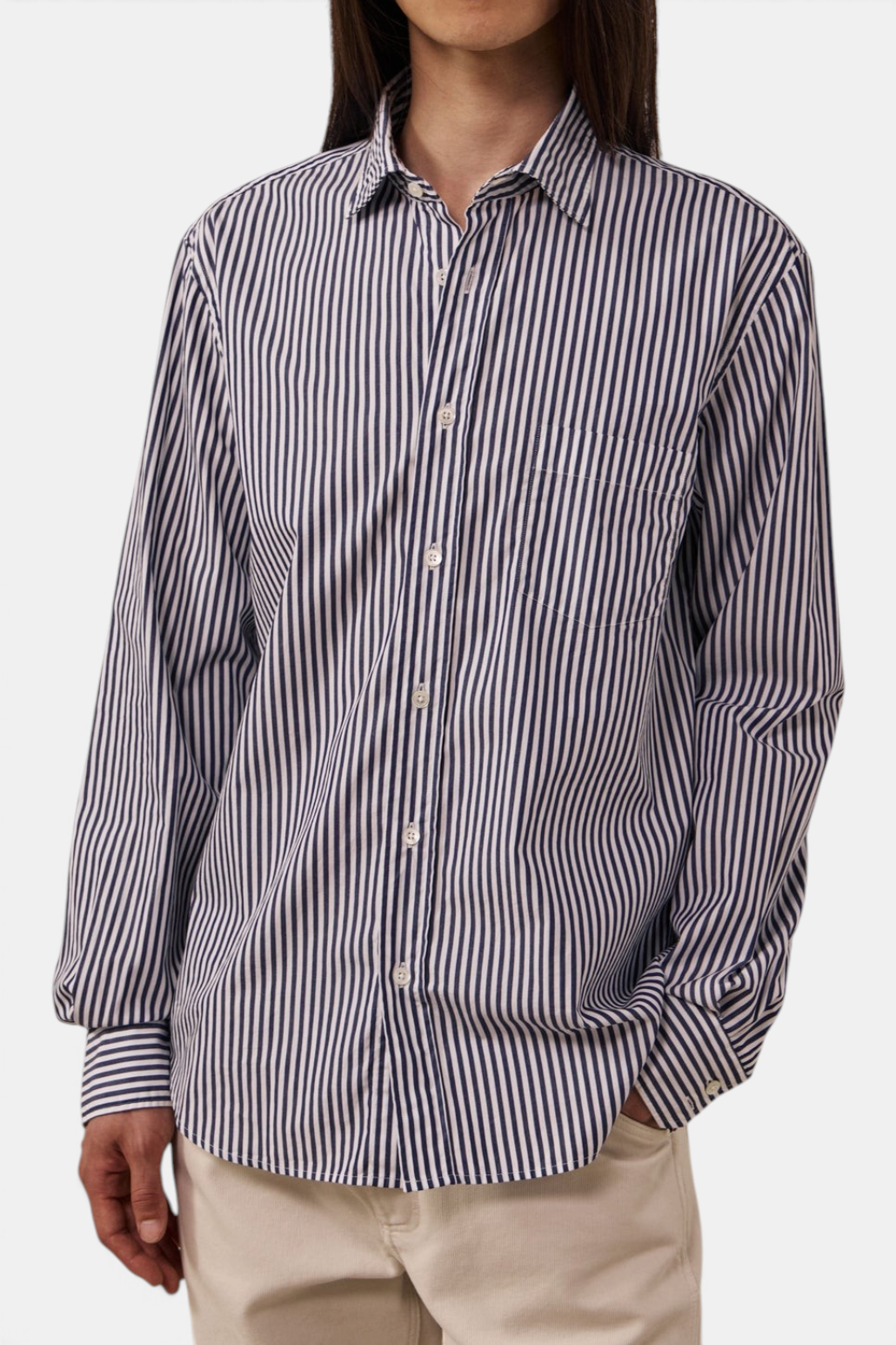 The Copper Shed Paul poplin shirt in navy and white vertical stripes with a chest pocket and mother-of-pearl buttons.