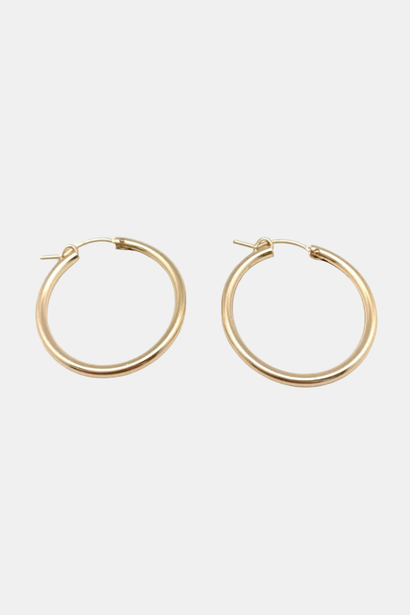 Gold hoop earrings on a white background