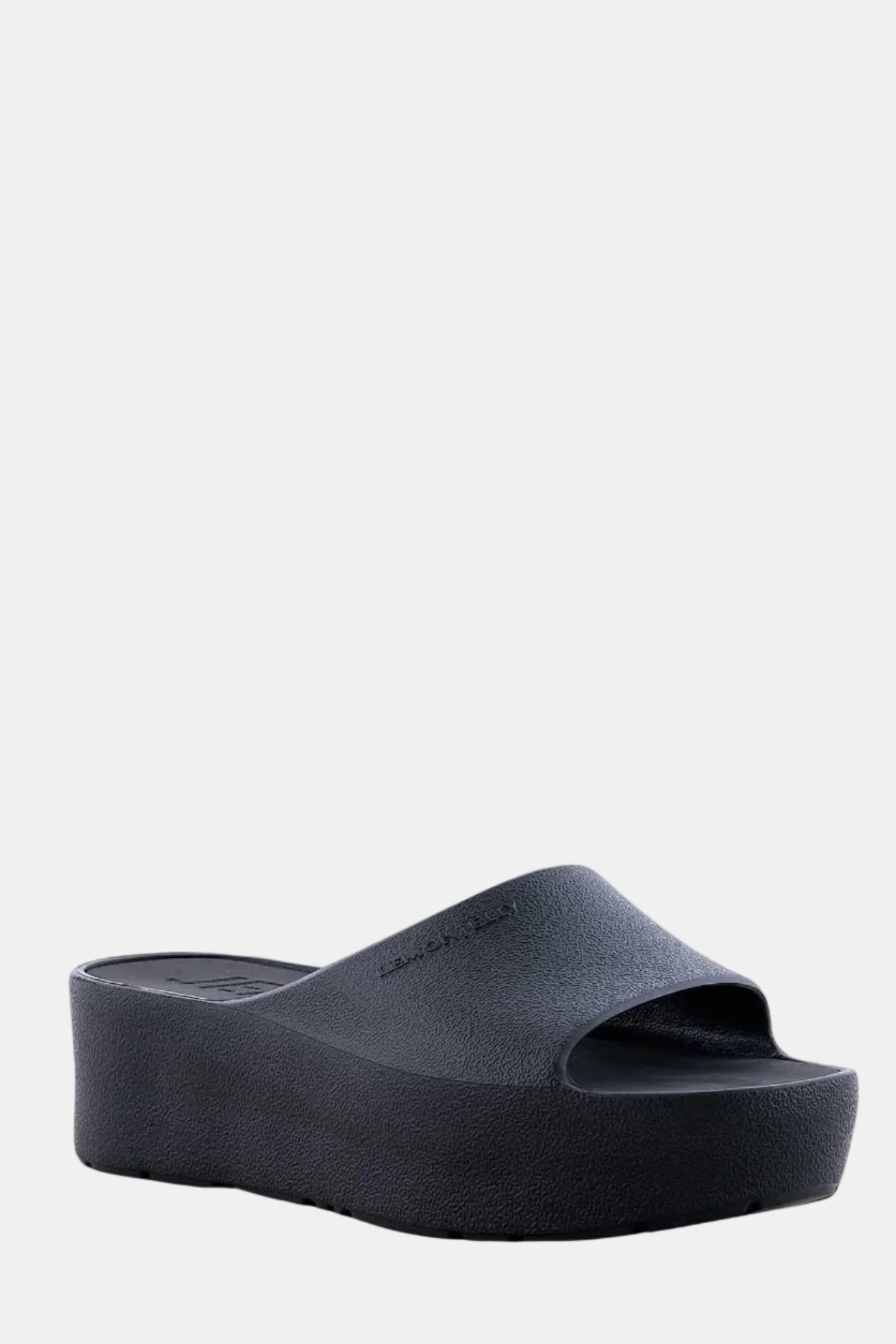 A black platform sandal with an open-toe design and a metallic glow.