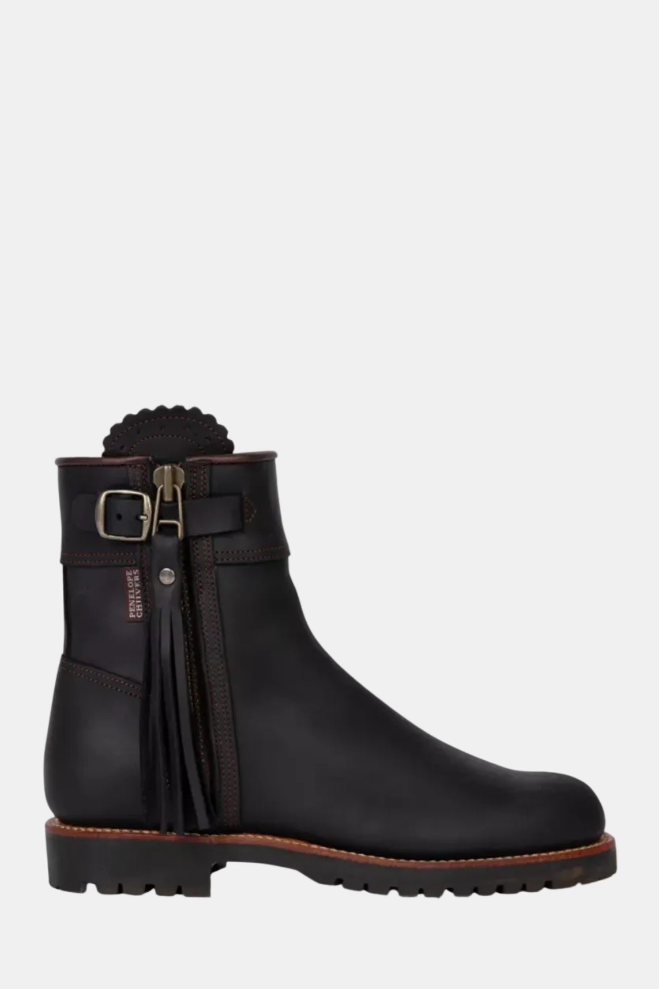 Black ankle boot with a strap and buckle on a white background