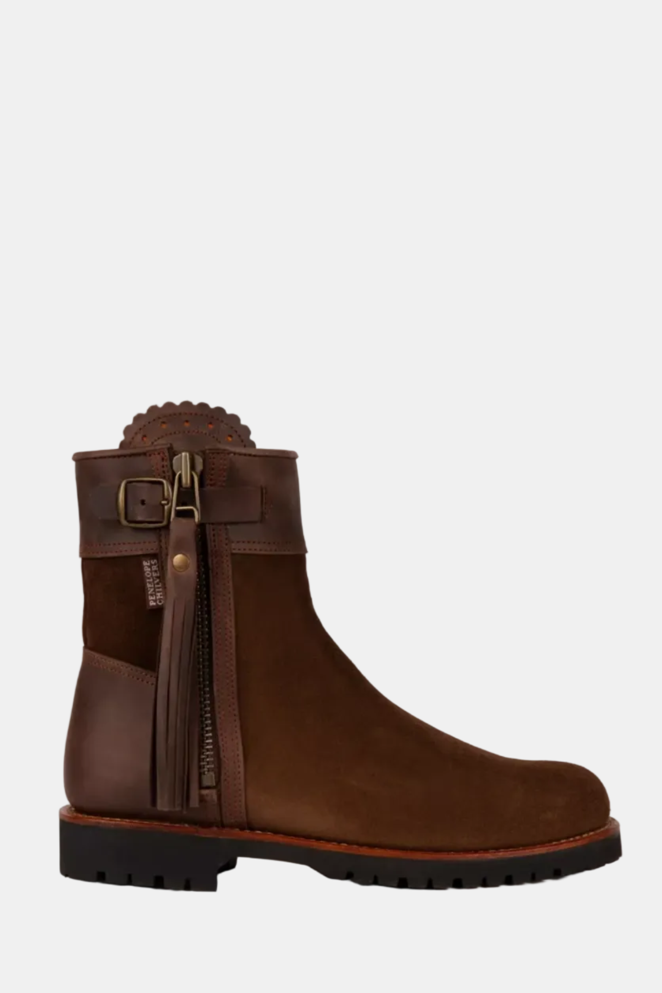 Brown boot with decorative strap and buckle on a white background