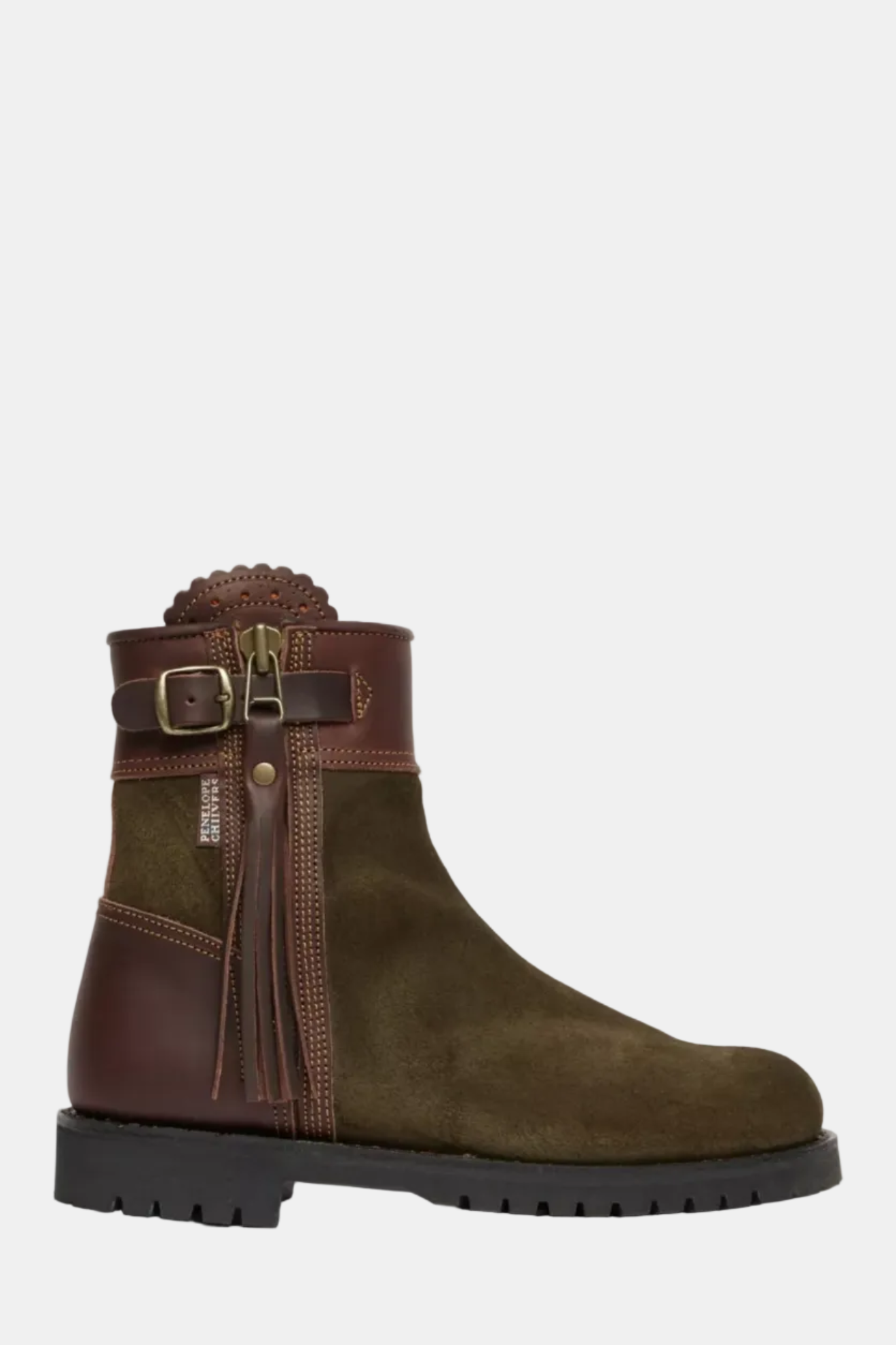 Brown suede boot with decorative strap and buckle on a white background