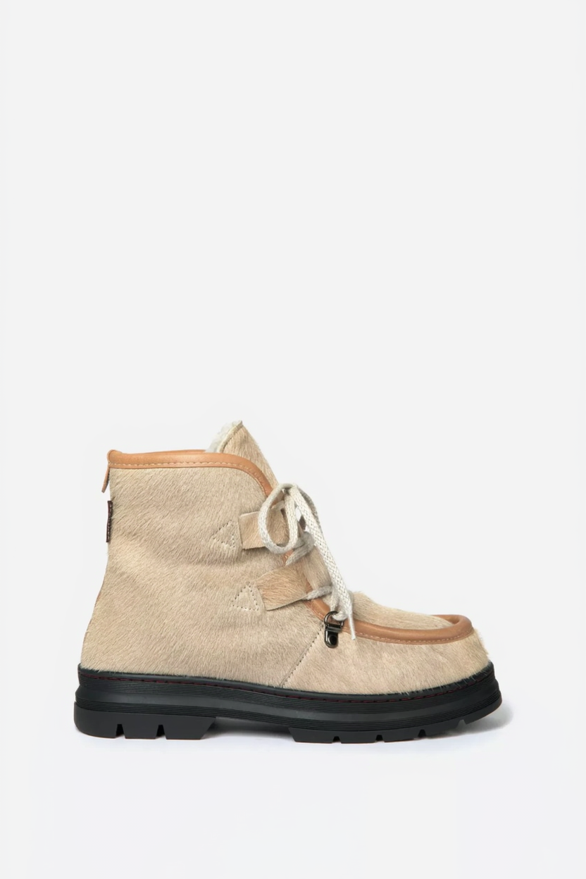 Beige boot with brown accents on a white background