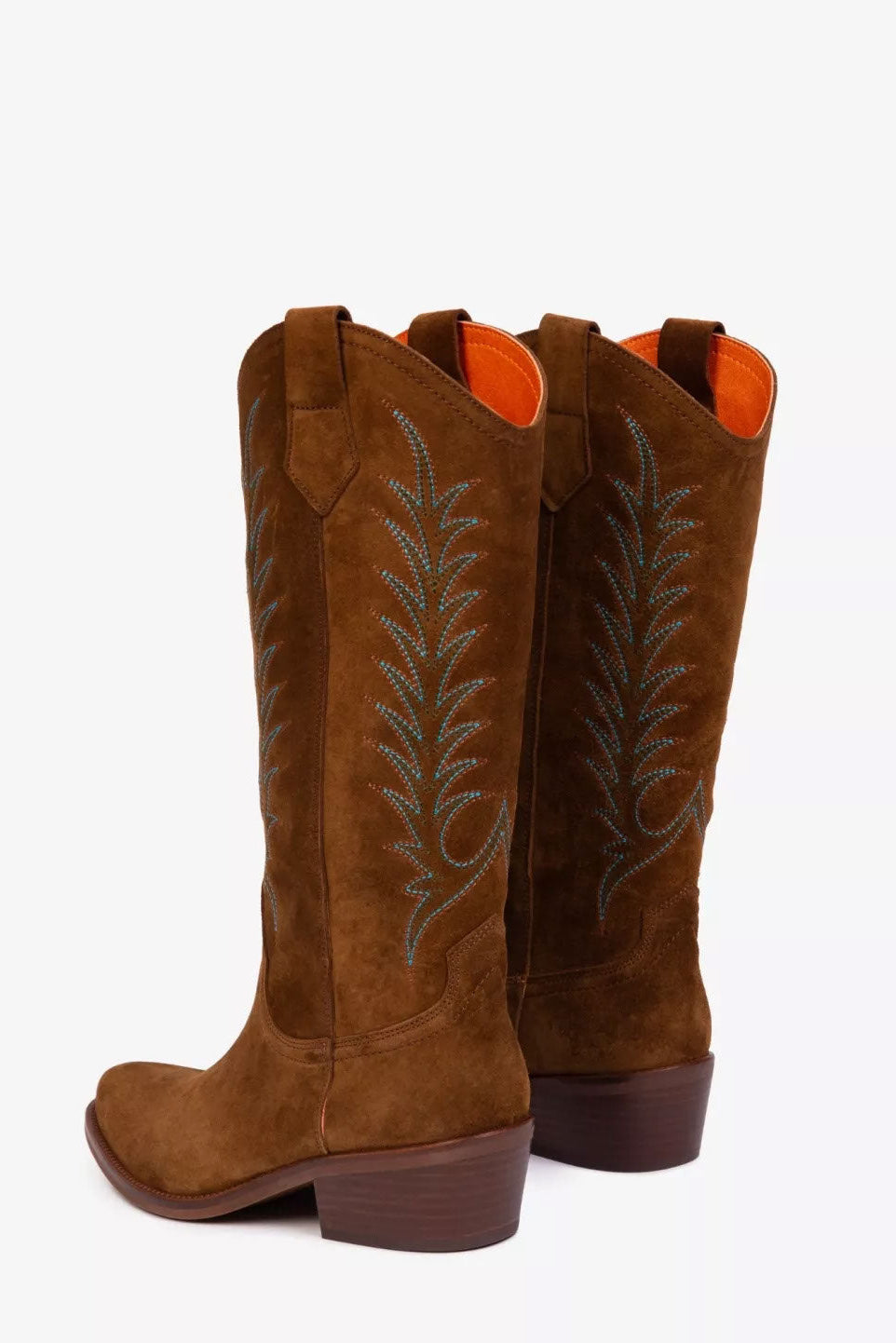 Pair of brown cowboy boots with decorative stitching on a white background