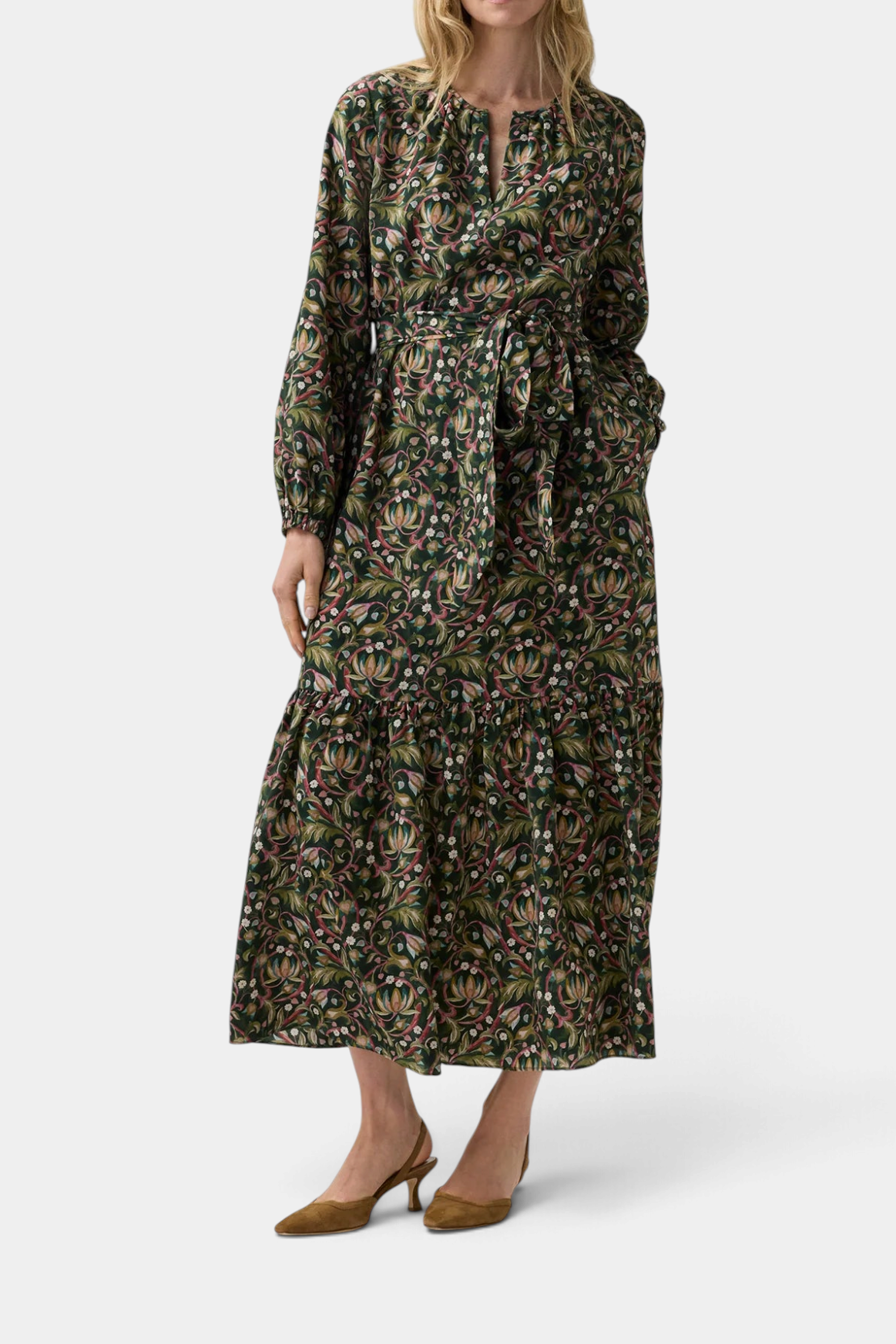 The Copper Shed Aba maxi dress in green floral Liberty Fabric silk twill with long sleeves and a self-tie belt.