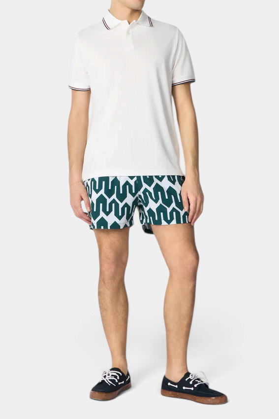 The Copper Shed Ademir swim shorts with green and white geometric print, elastic waist, and quick-dry fabric.