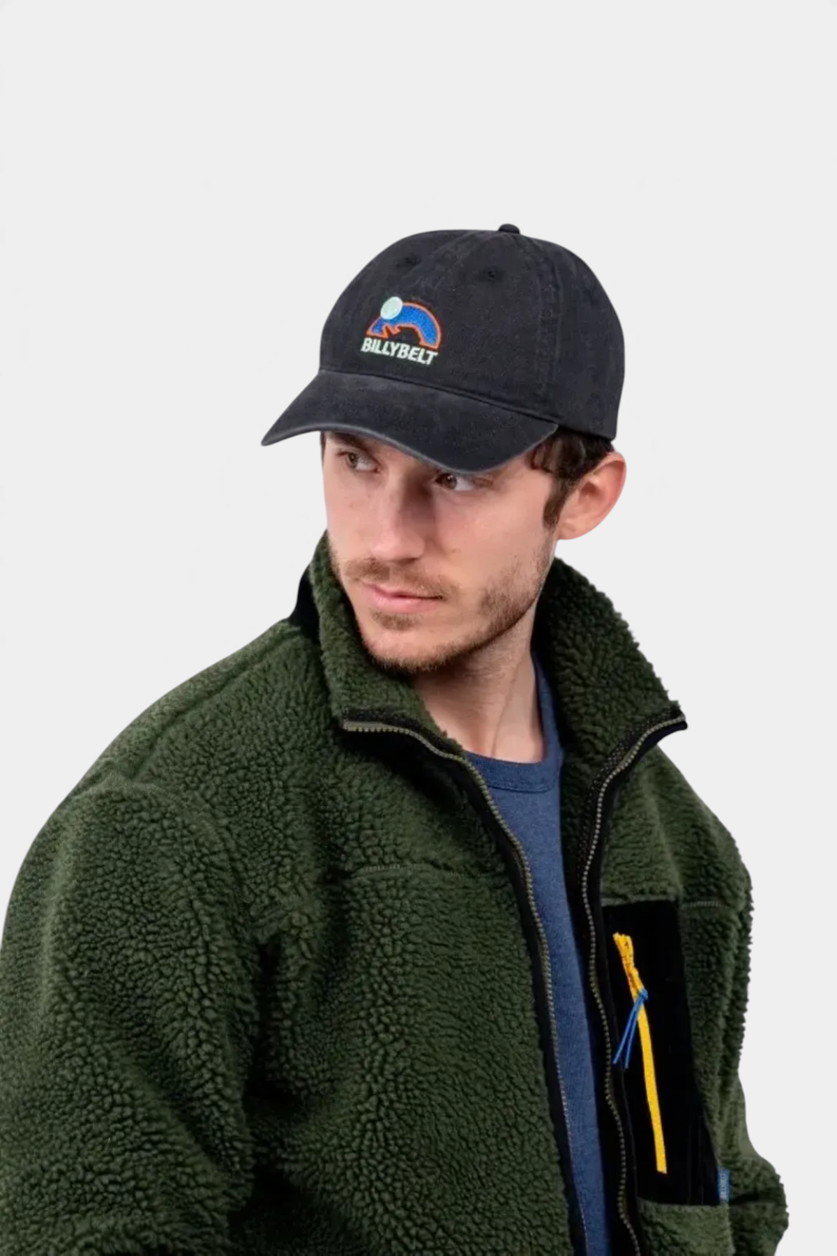 The Copper Shed anthracite 100% cotton cap with a faded effect and BILLYBELT logo worn by a man in a green fleece
